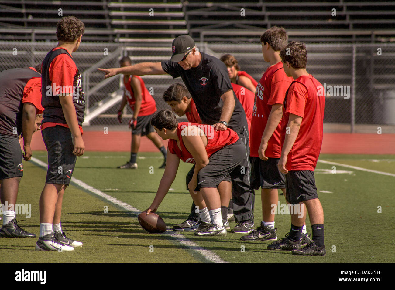 High school athletes get instructions during spring football practice in San Clemente, CA. Stock Photo