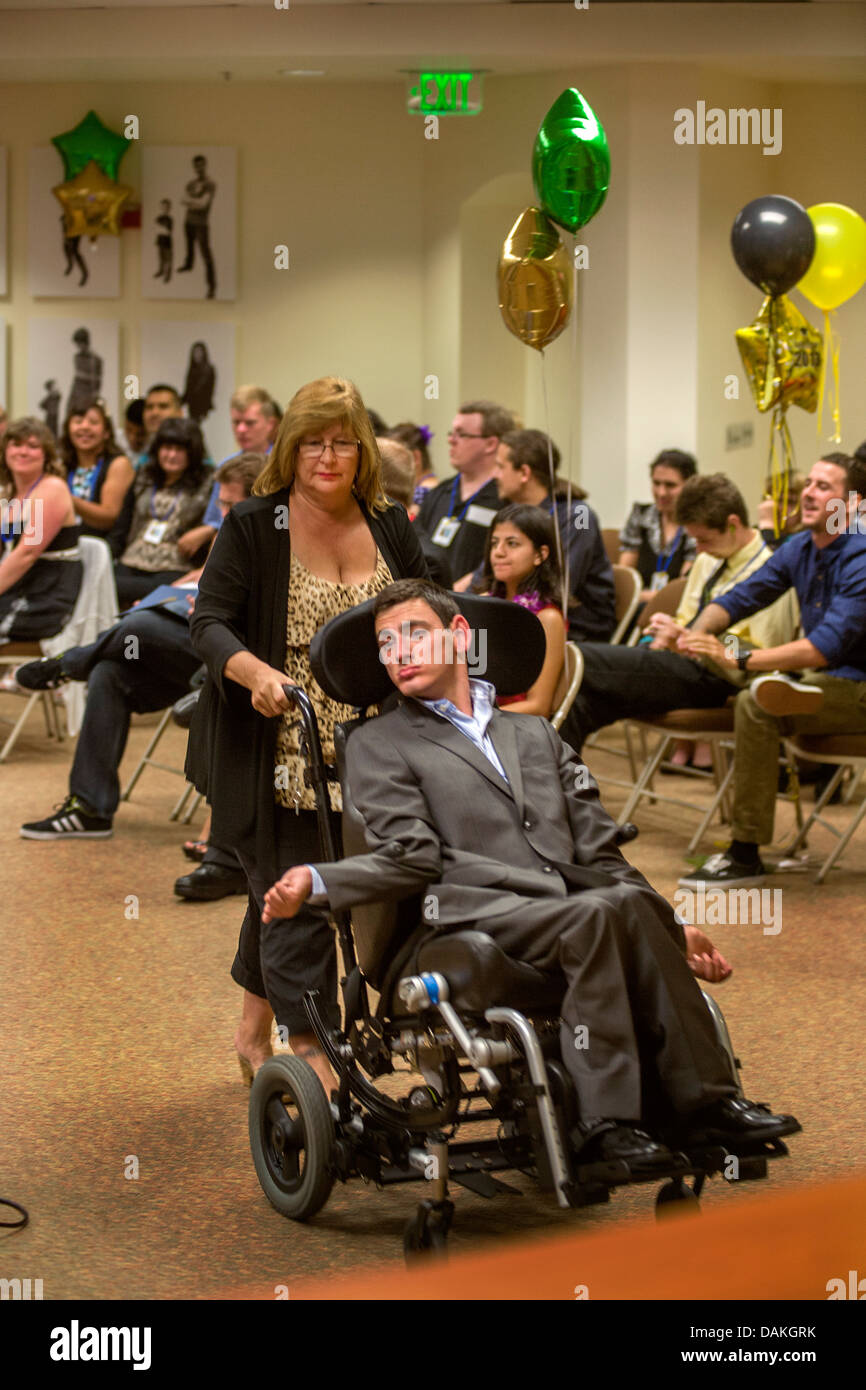 A wheelchairbound Adult Transition Program (ATP) student pushed by his