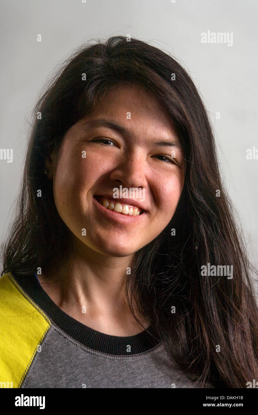 A happy racially-blended Asian-American 19-year-old girl smiles for her studio portrait in Laguna Niguel, CA. Stock Photo
