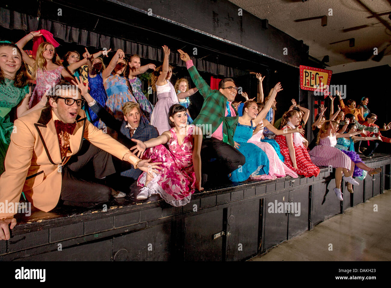 In 1950's clothing, the cast of a student production of the musical 'Grease' performs an ensemble number. Stock Photo