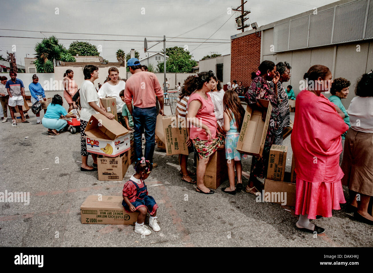 Hungry Hispanic and African American local LA residents line up for free charity food after the 1992 Rodney King race riots. Stock Photo