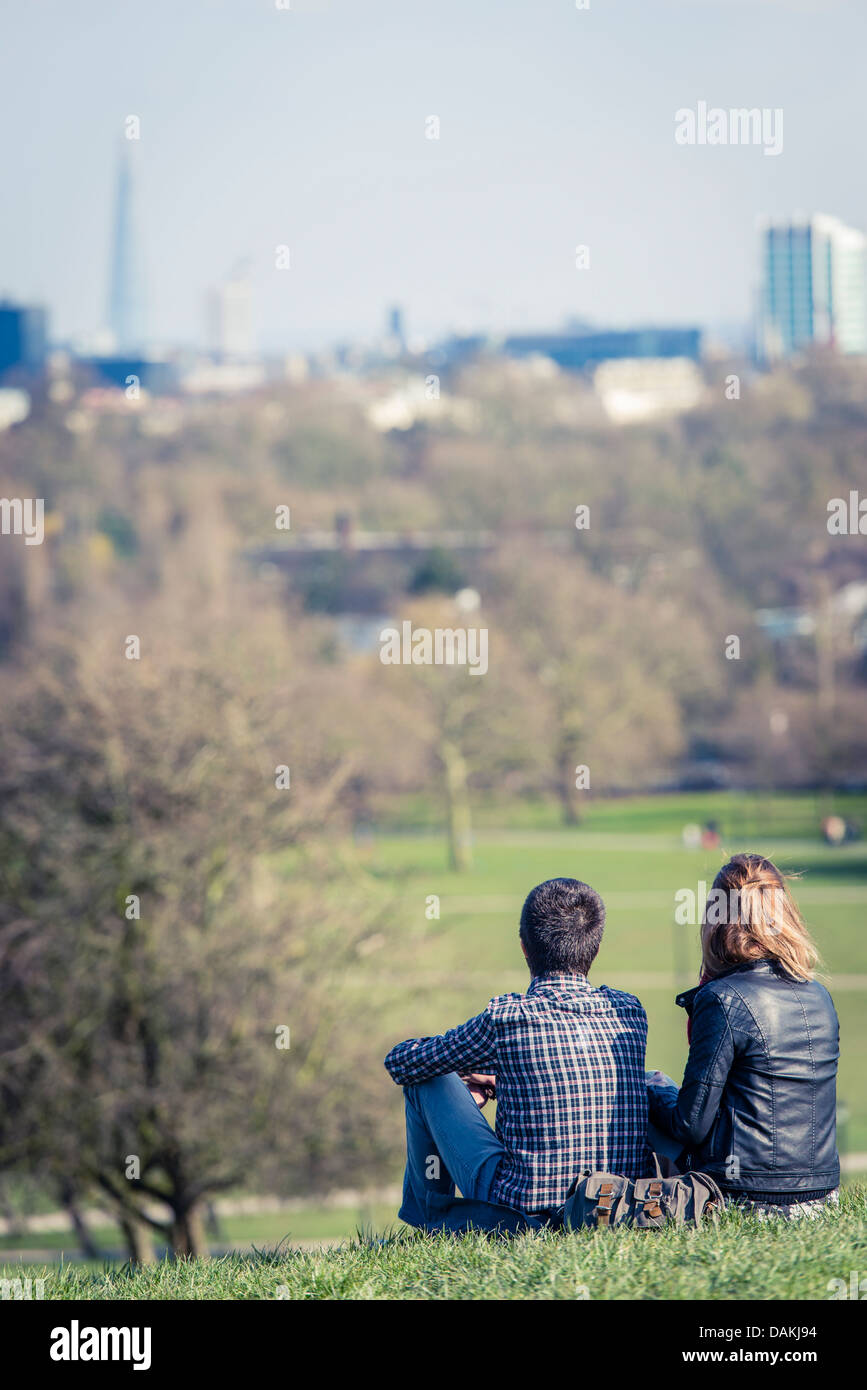 A couple on Primrose Hill looking out over London Stock Photo