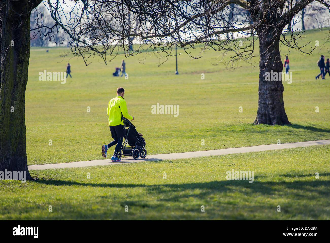 A jogger with a pram on Primrose Hill, London Stock Photo