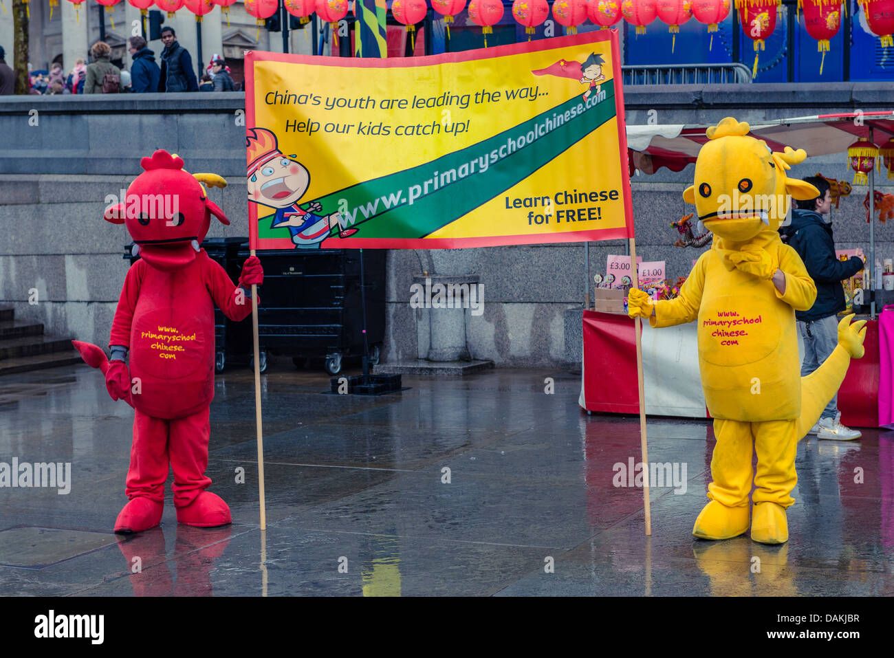 Mascots holding a banner for education during the London Chinese New Year 2013 celebrations Stock Photo