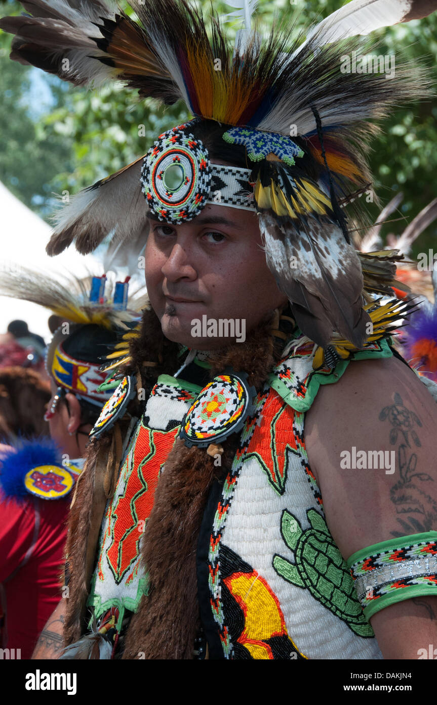 The proud Mohawk nation living in Kahnawake native community located on the south shore of the St Lawrence river in Quebec Canada celebrates it's annual Pow-Wow with traditional dances and drum music -July13-14 2013 Stock Photo