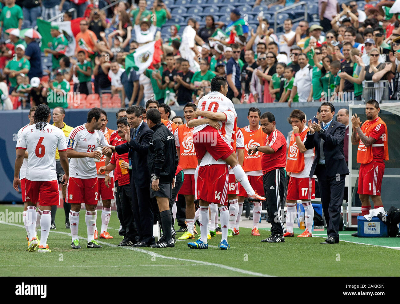 July 14, 2013 - Denver, Colorado, U.S - Mexico's MARCO FABIAN, center, gets congrats from team mates on the sidelines after scoring the 1st. goal of the game during the 1st. half at Sports Authority Field at Mile High Sunday afternoon. Mexico defeats Martinique 3-1. (Credit Image: © Hector Acevedo/ZUMAPRESS.com) Stock Photo