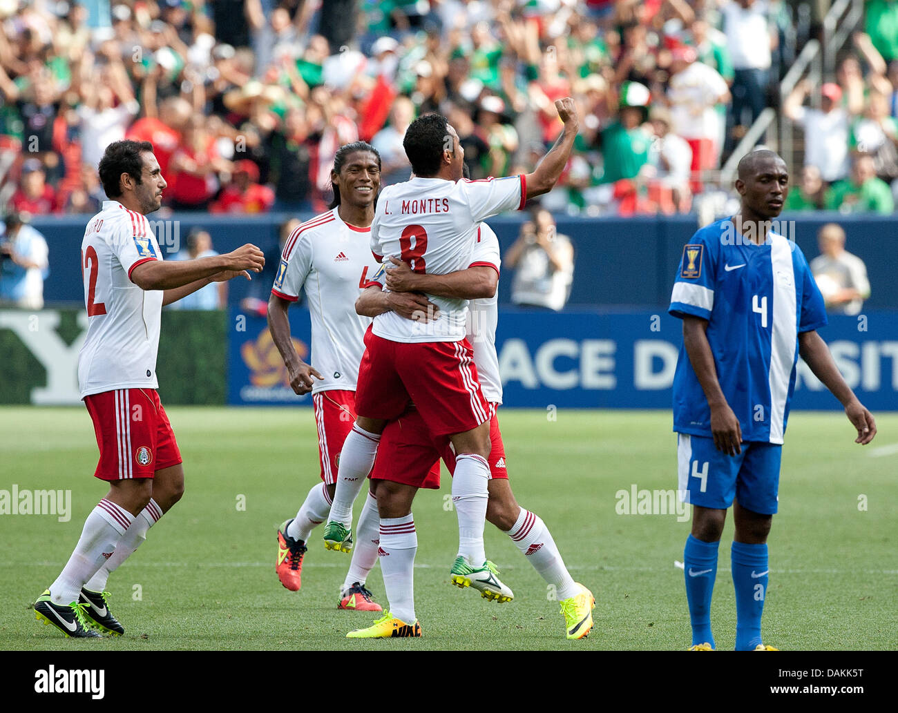 July 14, 2013 - Denver, Colorado, U.S - Mexico's LUIS MONTES, center, gets hugged by team mate after scoring the 2nd. goal of the game during the 1st. half at Sports Authority Field at Mile High Sunday afternoon. Mexico defeats Martinique 3-1. (Credit Image: © Hector Acevedo/ZUMAPRESS.com) Stock Photo