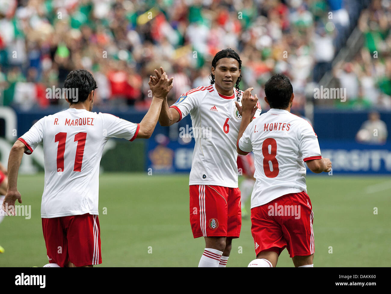 July 14, 2013 - Denver, Colorado, U.S - Mexico's CARLOS PENA, gives high fives to team mates after team mate MARCO FABIAN scores the first goal of the game during the 1st. half at Sports Authority Field at Mile High Sunday afternoon. Mexico defeats Martinique 3-1. (Credit Image: © Hector Acevedo/ZUMAPRESS.com) Stock Photo