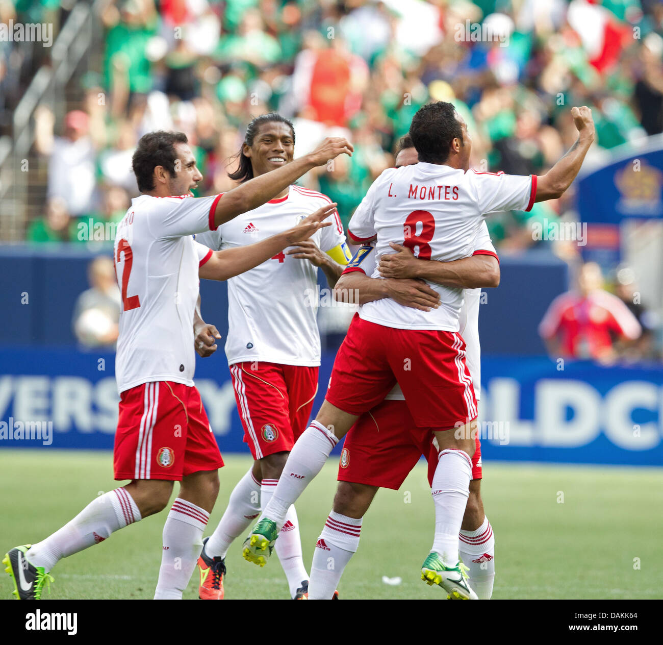 July 14, 2013 - Denver, Colorado, U.S - Mexico's LUIS MONTES, right, is congratulated by team mates after scoring the 2nd. goal of the game for his team during the 1st. half at Sports Authority Field at Mile High Sunday afternoon. Mexico defeats Martinique 3-1. (Credit Image: © Hector Acevedo/ZUMAPRESS.com) Stock Photo
