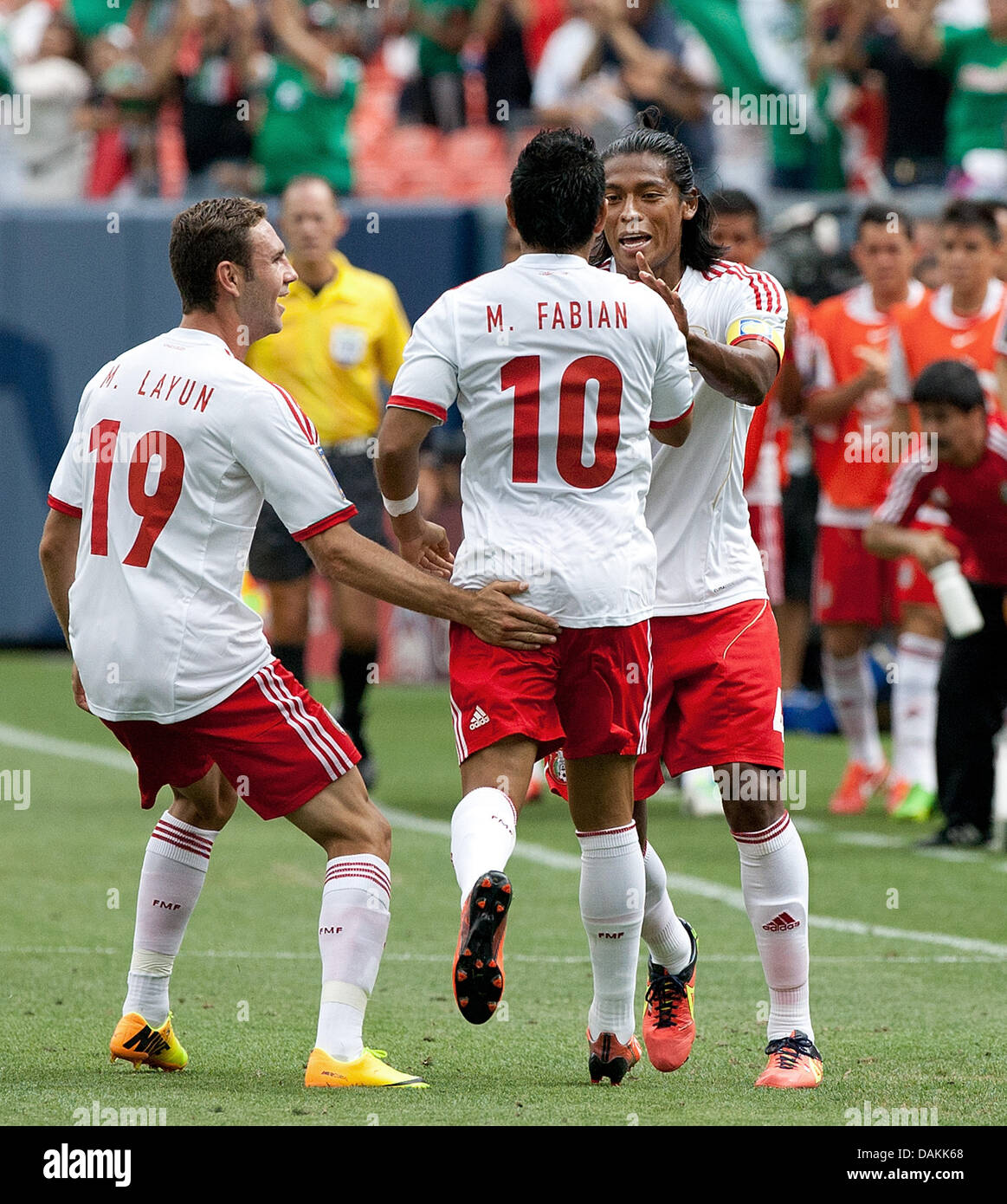 July 14, 2013 - Denver, Colorado, U.S - Mexico's MARCO FABIAN, center, gets congrats from team mates after scoring the 1st. goal of the game for his team during the 1st. half at Sports Authority Field at Mile High Sunday afternoon. Mexico defeats Martinique 3-1. (Credit Image: © Hector Acevedo/ZUMAPRESS.com) Stock Photo