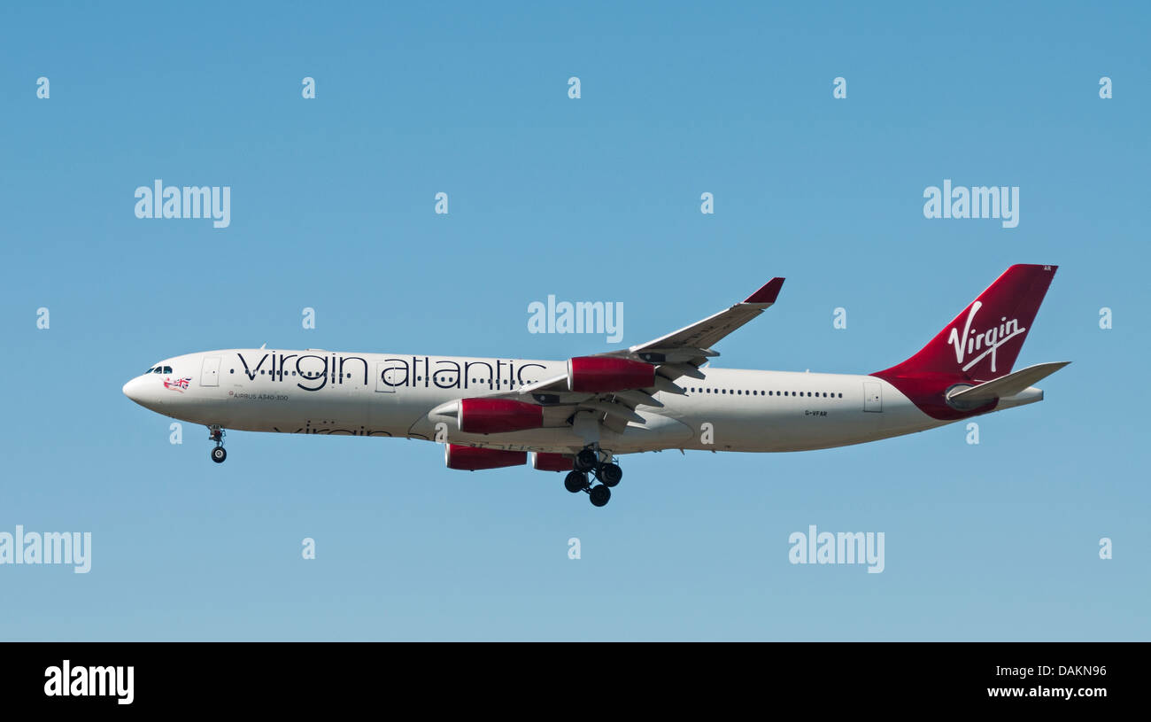 A Virgin Atlantic Airways Airbus A340-300 (313X) in flight and on final approach for landing. Stock Photo