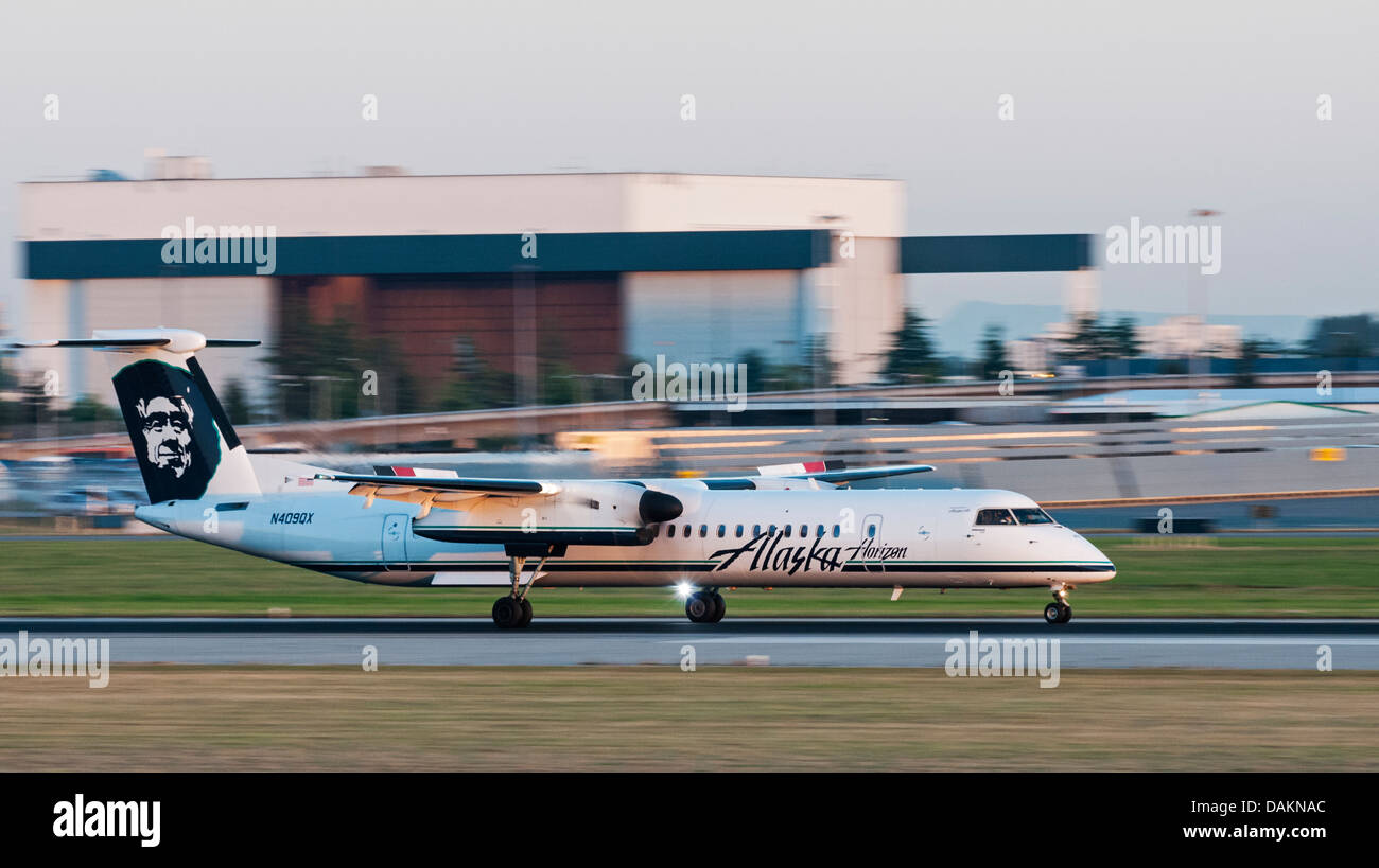 A Bombardier Q400 (DHC-8-401Q) in Alaska Airlines/Horizon Air livery lands at Vancouver International Airport (Canada). Stock Photo