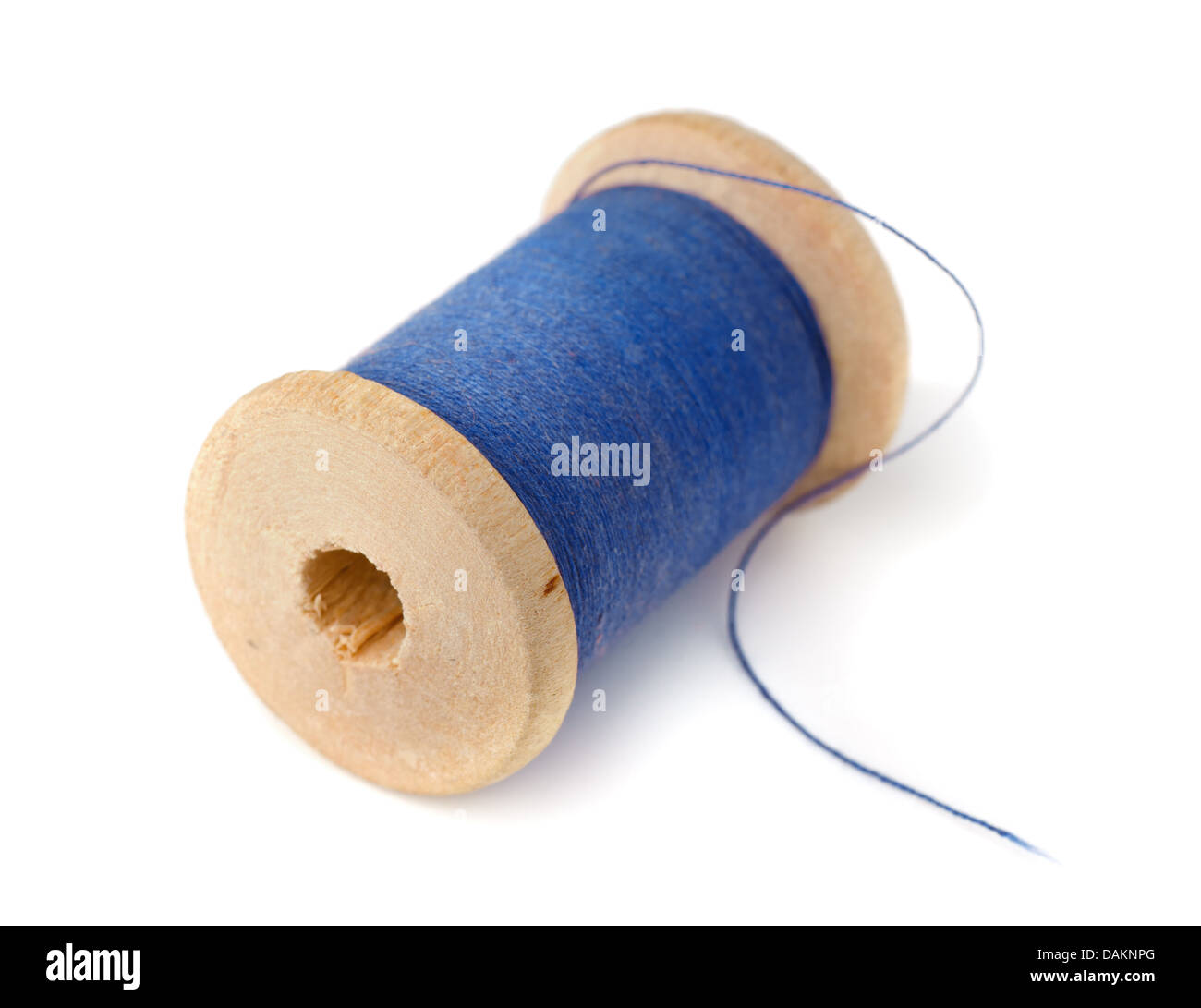 Wooden spool of blue thread isolated on white Stock Photo