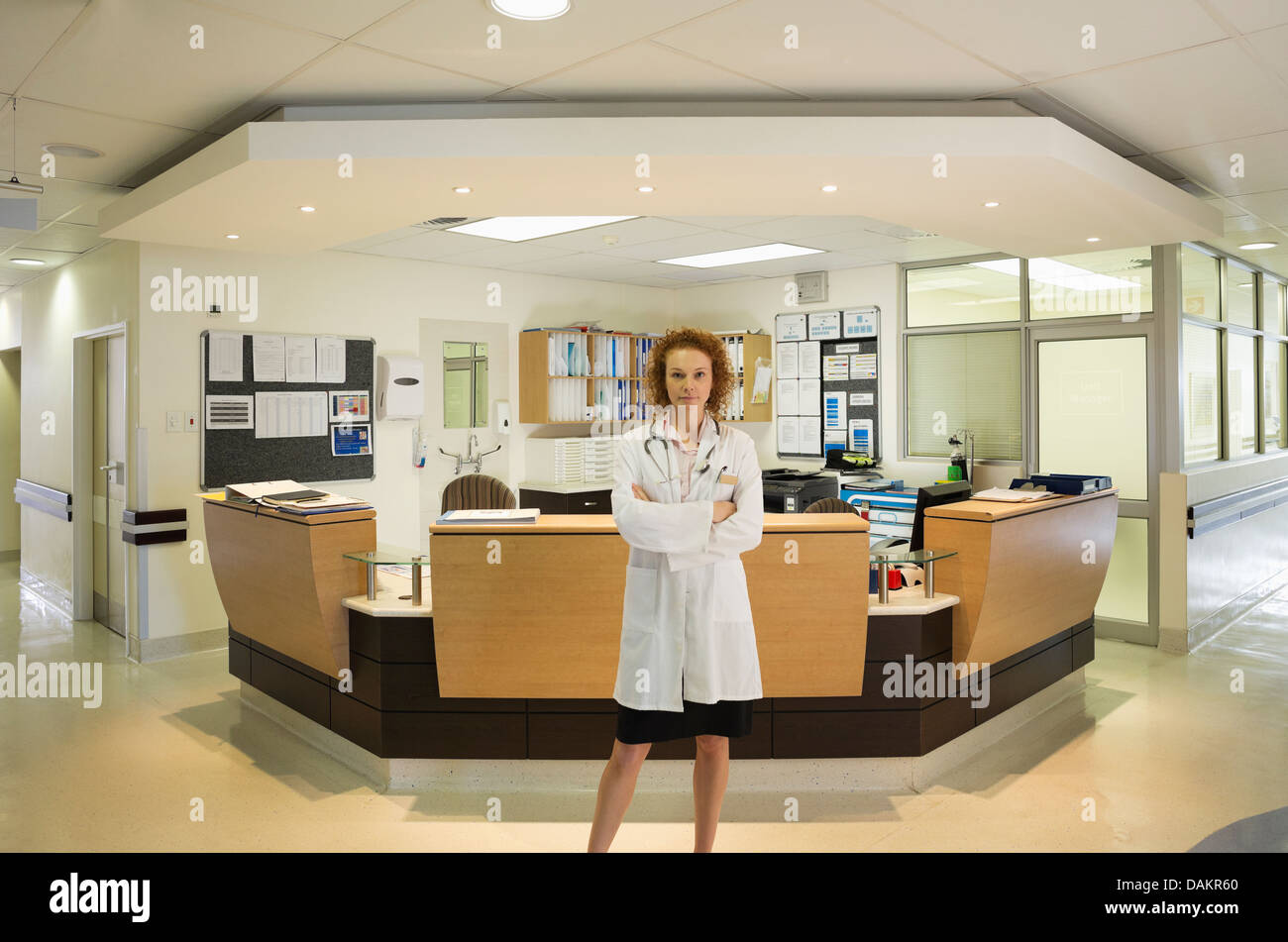 Doctor standing in hospital hallway Stock Photo