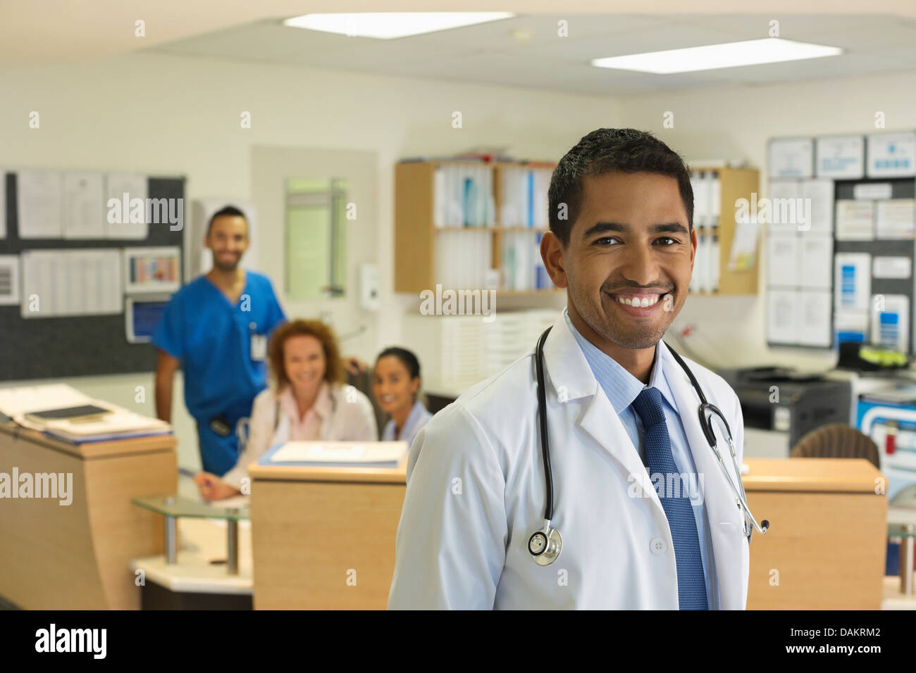 Doctor smiling in hospital hallway Stock Photo