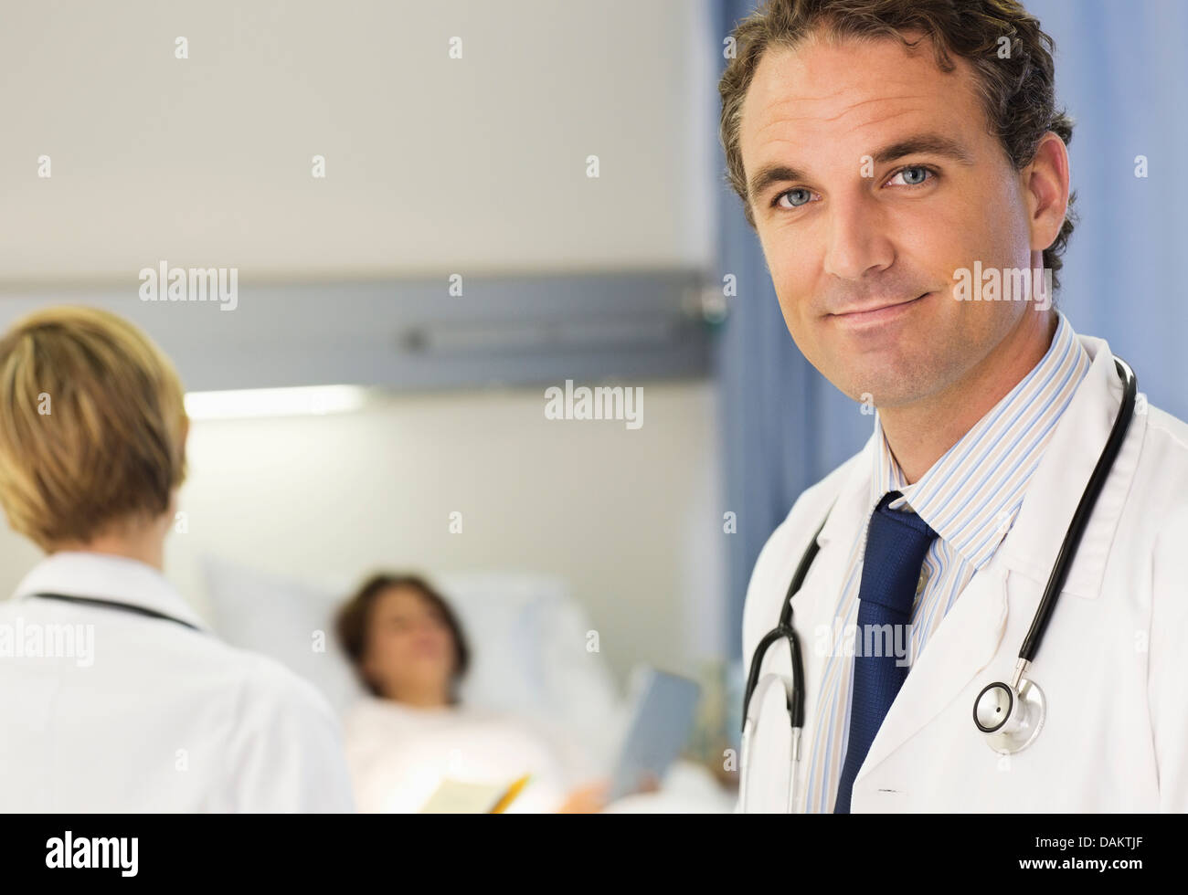 Doctor Smiling In Hospital Room Stock Photo Alamy