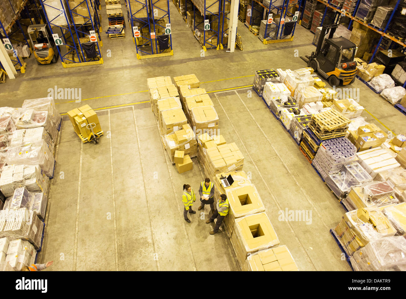 Workers talking in warehouse Stock Photo