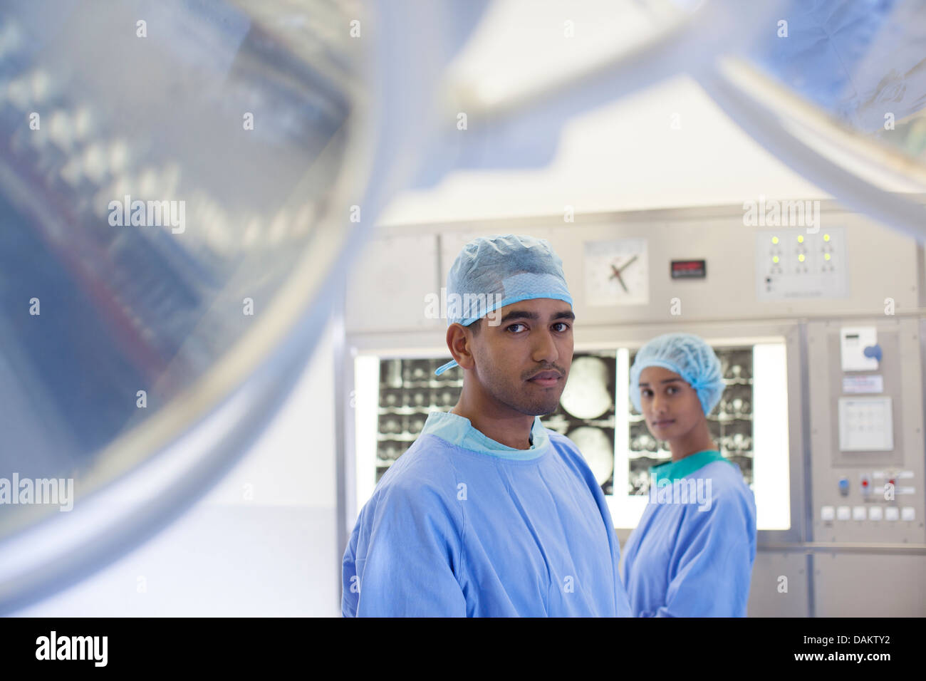 Surgeons standing in operating room Stock Photo