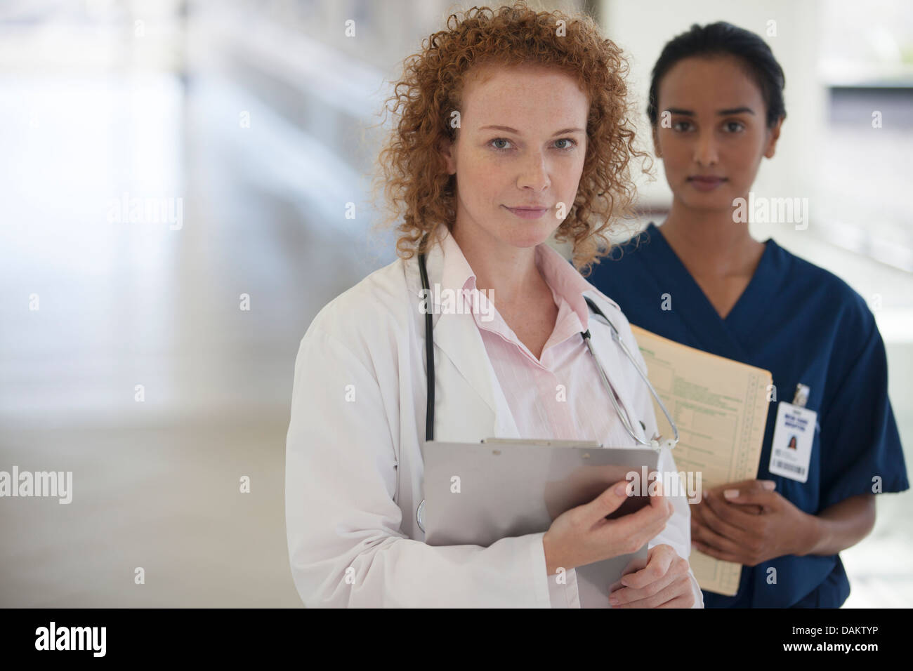 Doctor and nurse standing in hallway Stock Photo