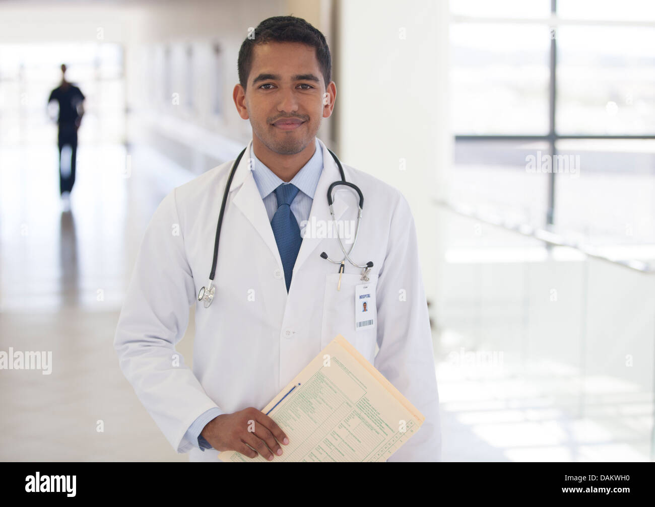 Doctor smiling in hospital hallway Stock Photo