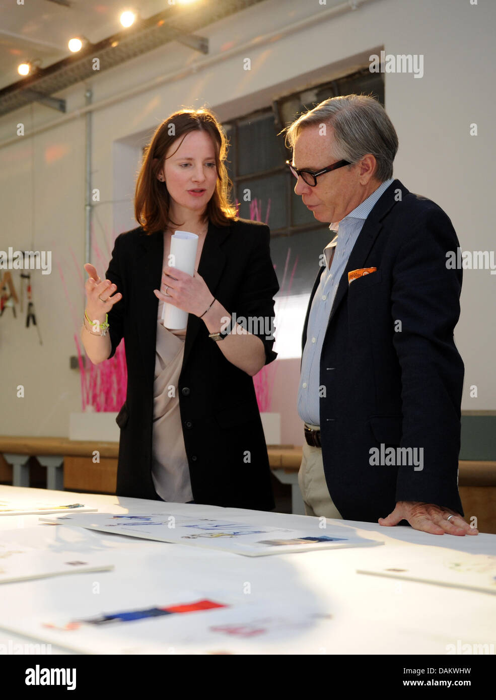 US fashion designer Tommy Hilfiger and fashion journalist Silke Wichert  look at entries for an internal competition at the school during a visit to  the Akademie JAK for fashion design in Hamburg, Germany,