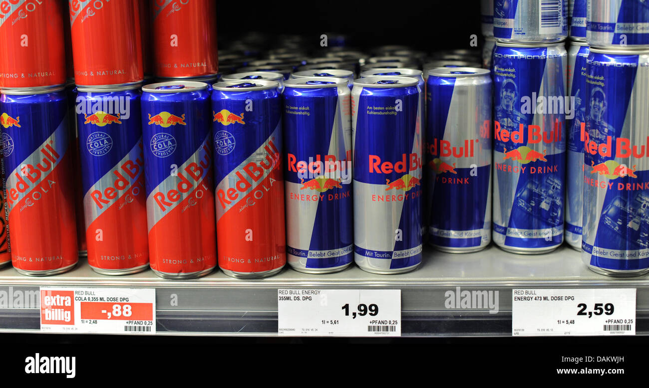 Cans of the energy drink Red Bull sit on the shelf in a supermarket in Hanover, Germany, 05 May 2011. Photo: Julian Stratenschulte Stock Photo