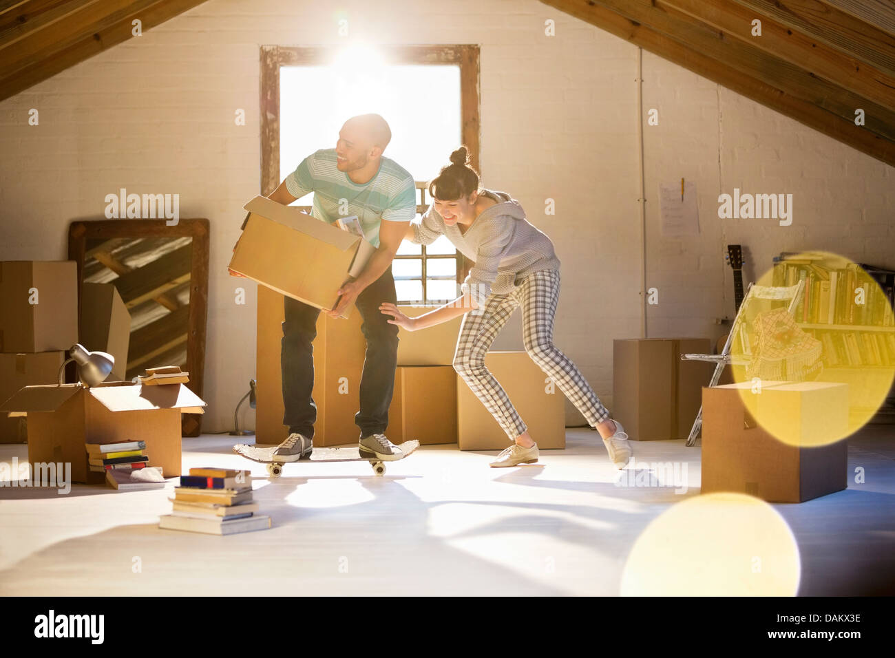 Couple unpacking boxes in attic Stock Photo