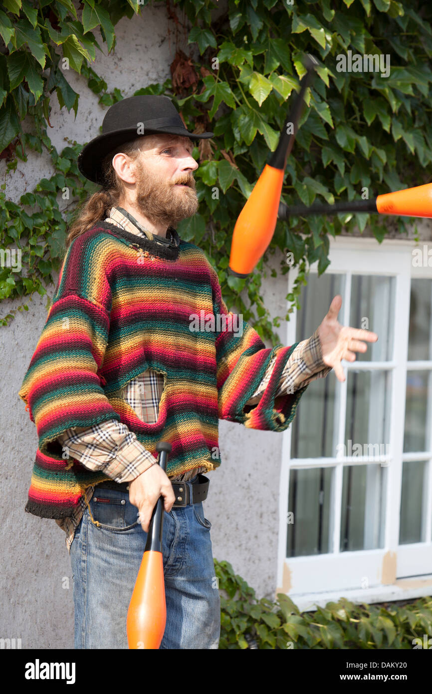 Male Juggler with clubs on a Oxford street, Oxfordshire, England, UK Stock Photo