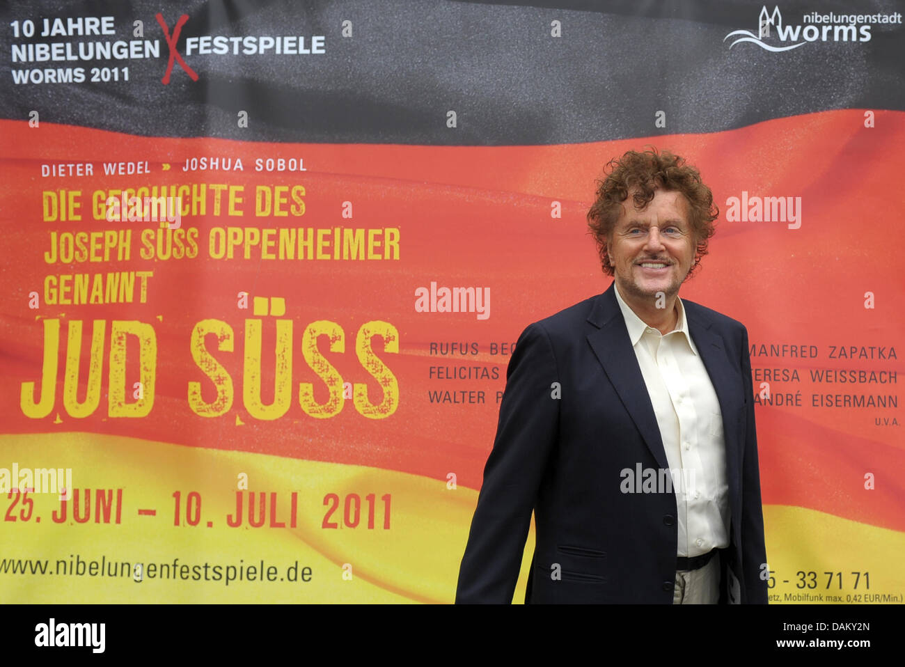 Director Dieter Wedel poses in front of a poser for the play Jew Suss in Worms, Germany, 12 May 2011. The play 'The story of Joseph Suss Oppenheimer, called Jew Suss' is presented to the public from 25 June 2011 onwards. Foto: Ronald Wittek Stock Photo