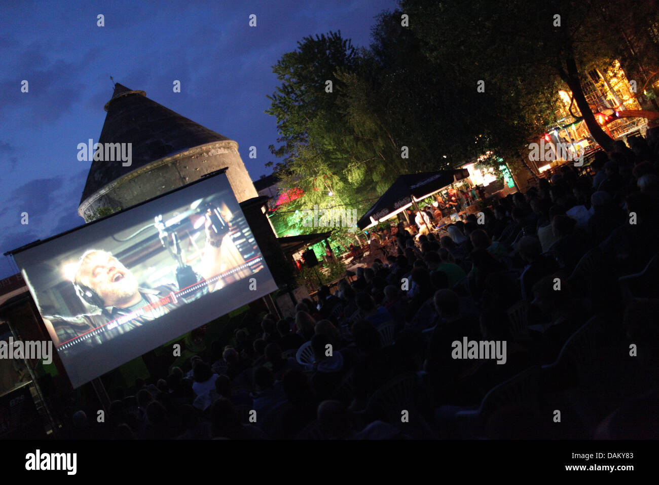 Guests watch 'Radio Rock Revolution' at the Club Cassiopeia in Berlin, Germany, 11 May 2011. With rising temperature, the open-air cinema season begins and lasts until autumn. Photo: Florian Schuh Stock Photo