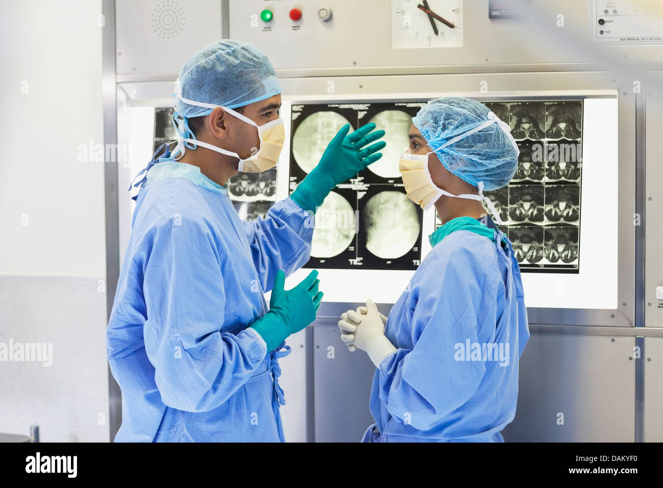 Surgeons examining x-rays in hospital Stock Photo