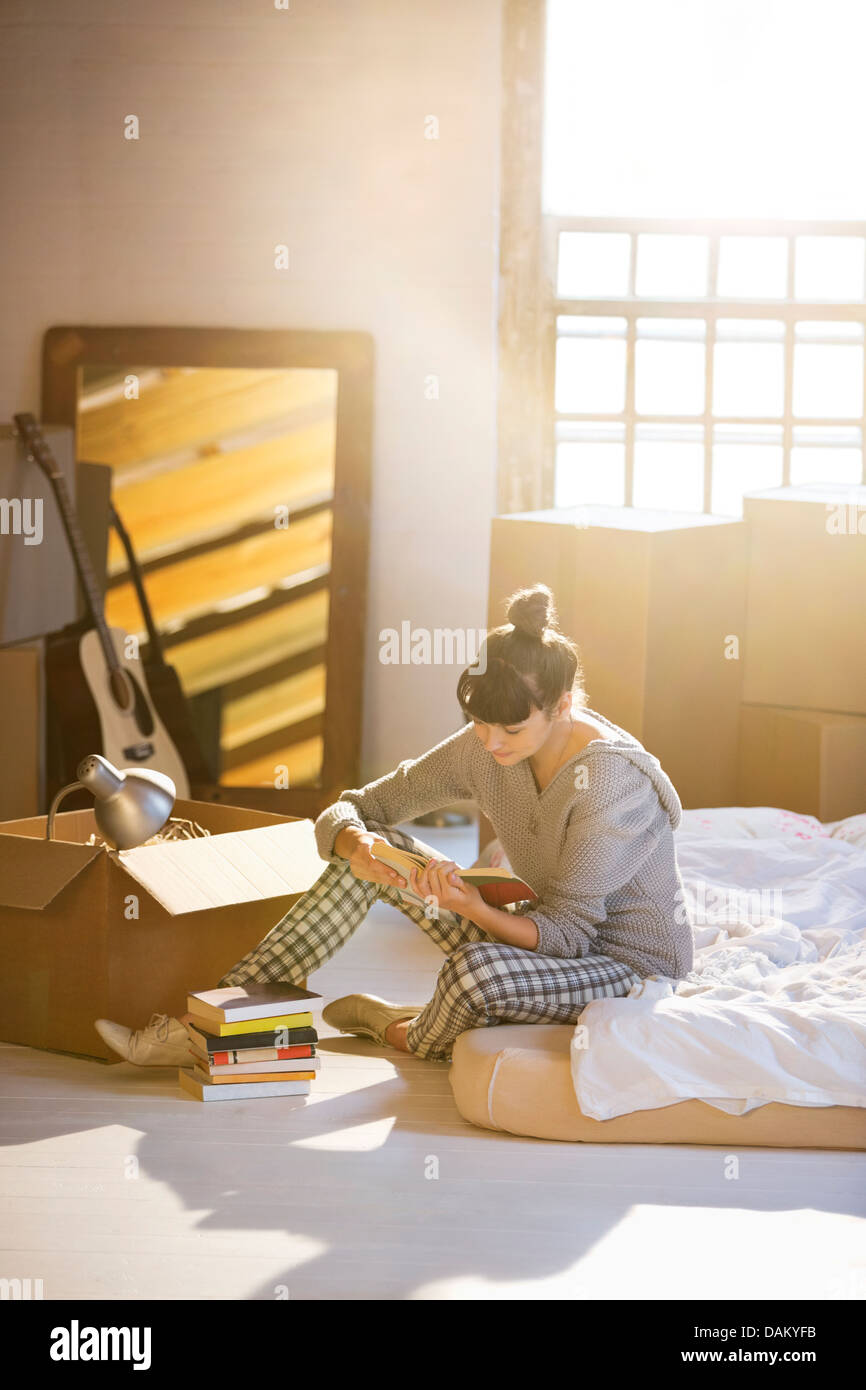 Woman unpacking box in new home Stock Photo
