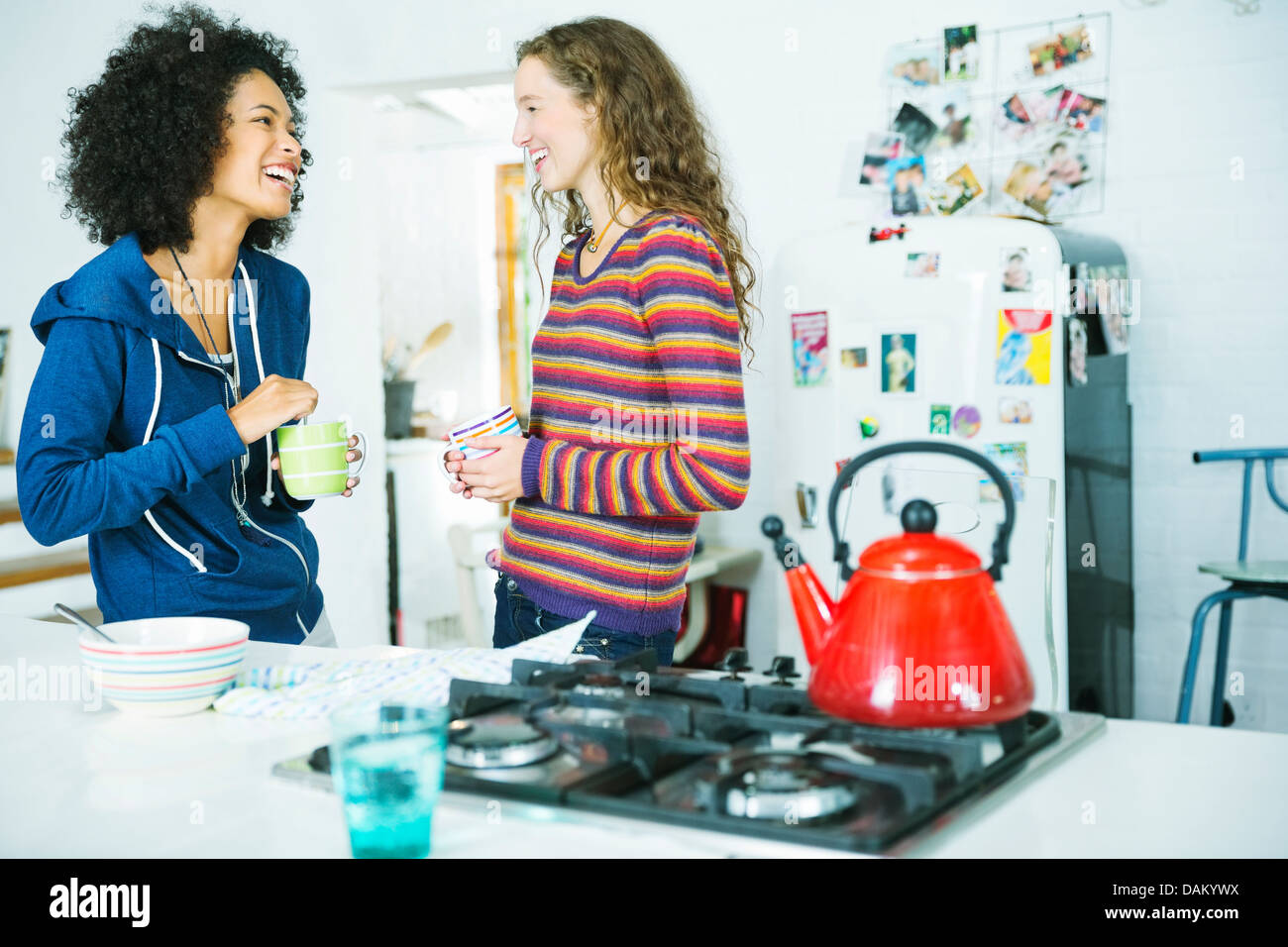 Women talking in kitchen Stock Photo
