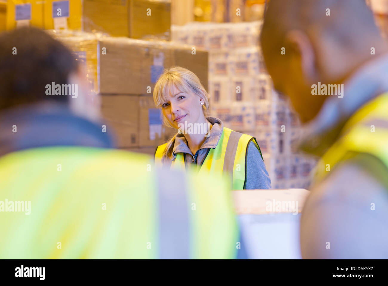 Workers talking in warehouse Stock Photo - Alamy