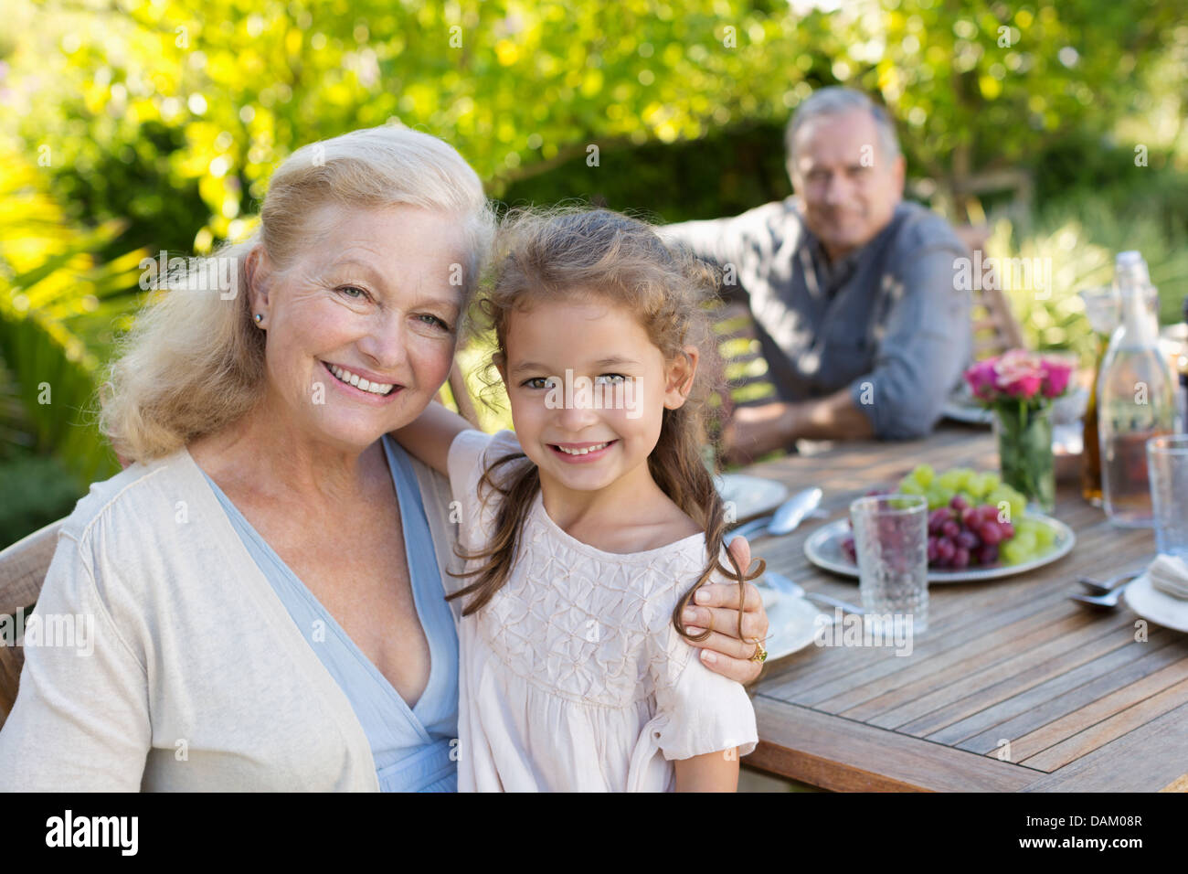 Older woman and granddaughter smiling outdoors Stock Photo