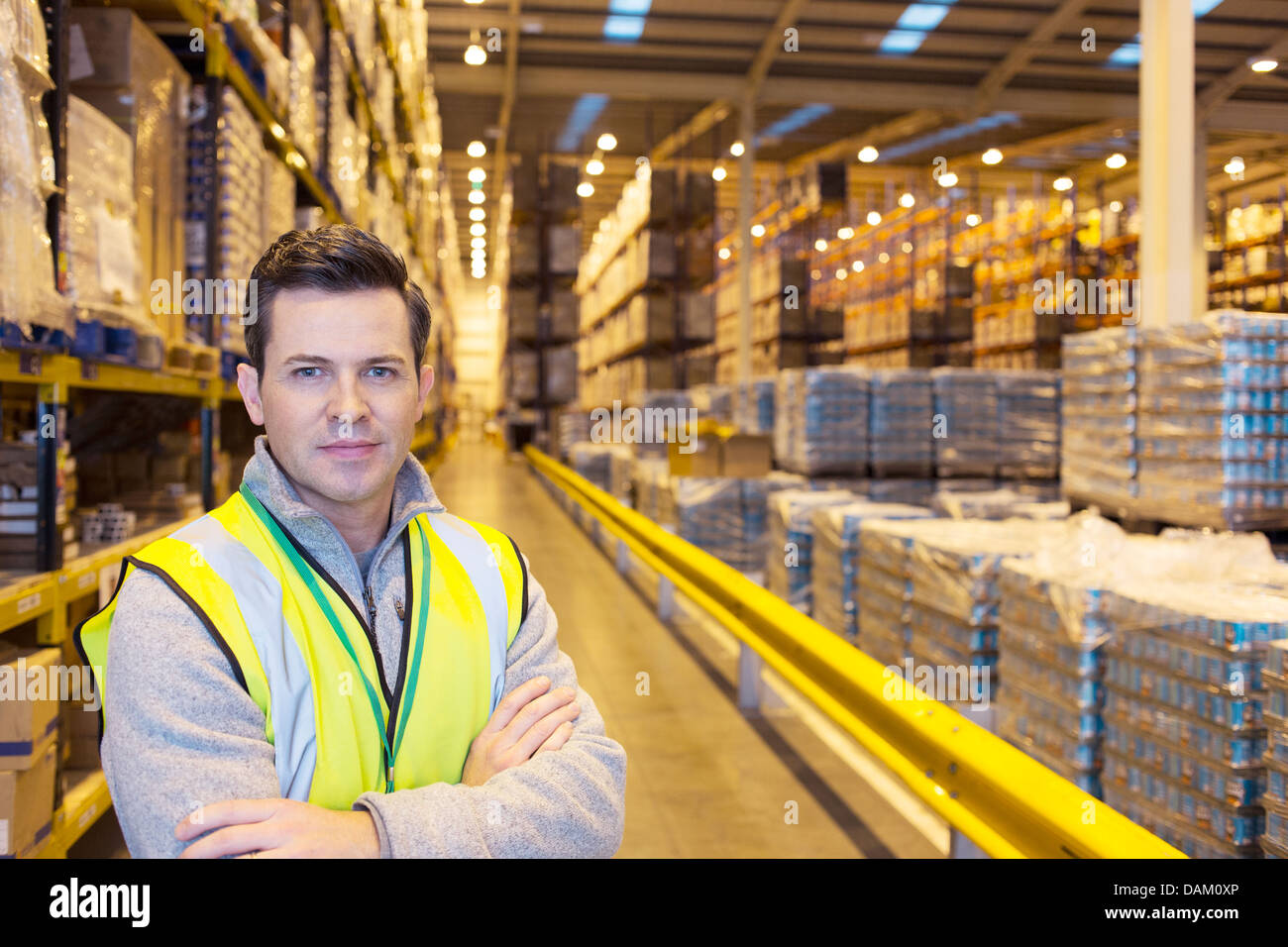 Worker smiling in warehouse Stock Photo