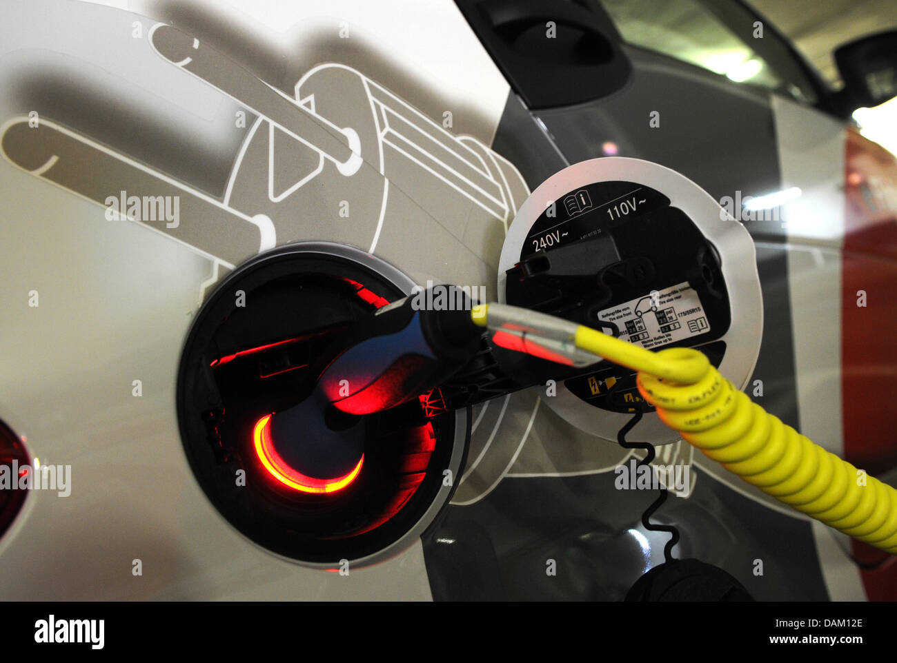 A cable is connected to the battery outlet of a electricpowered Smart car of Deutsche Bahn