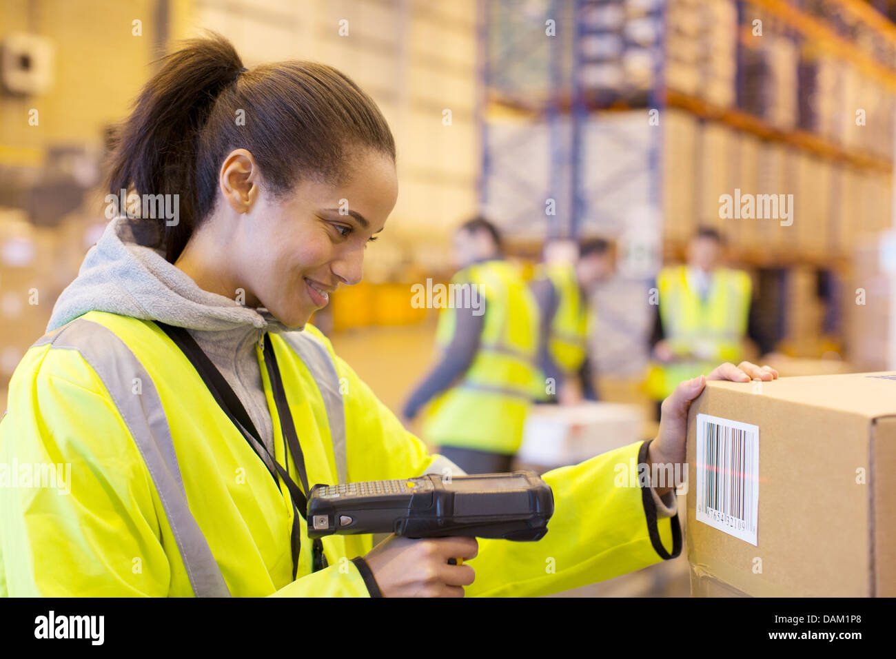Worker scanning box in warehouse Stock Photo