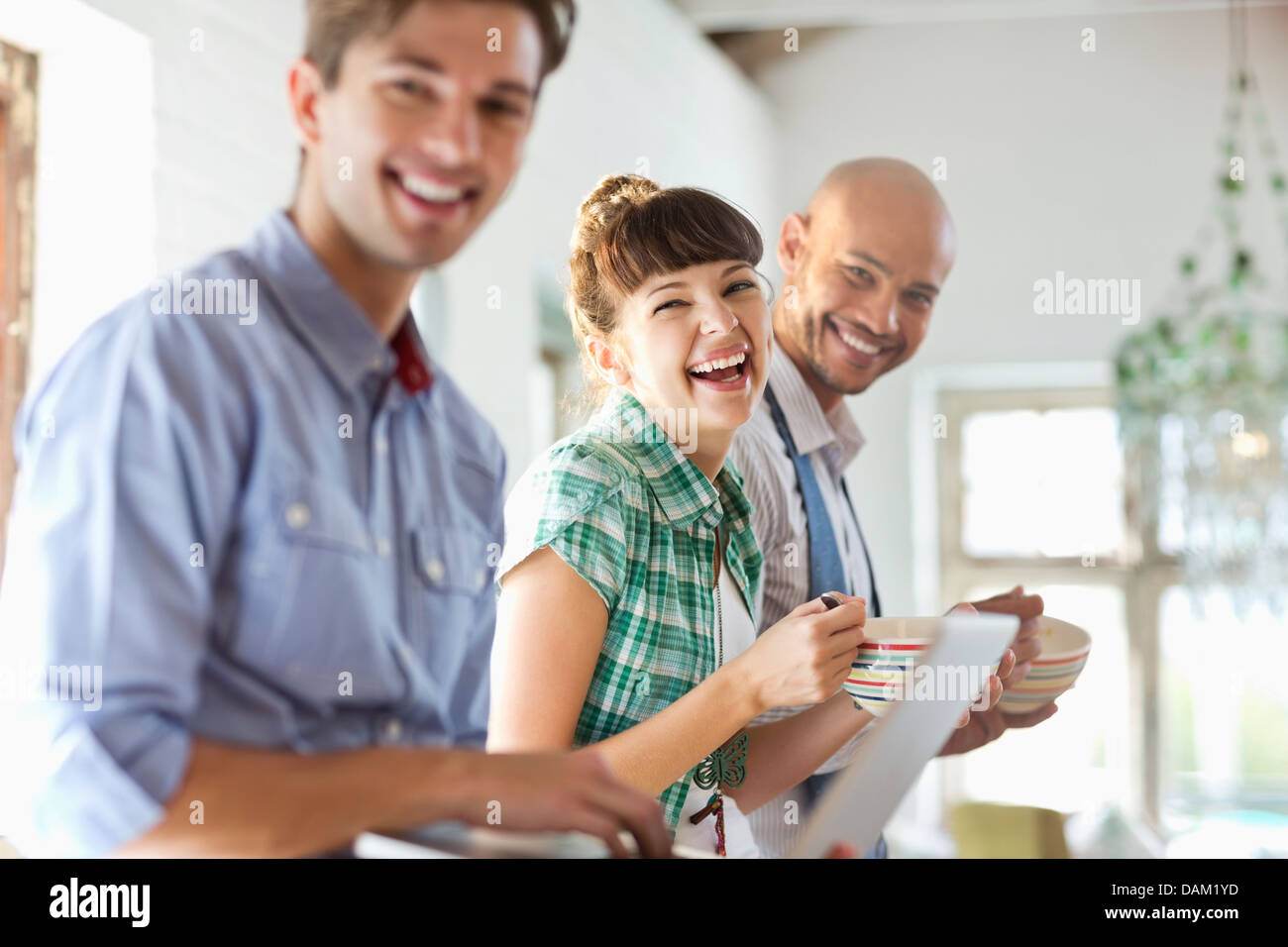 Friends having breakfast together in kitchen Stock Photo