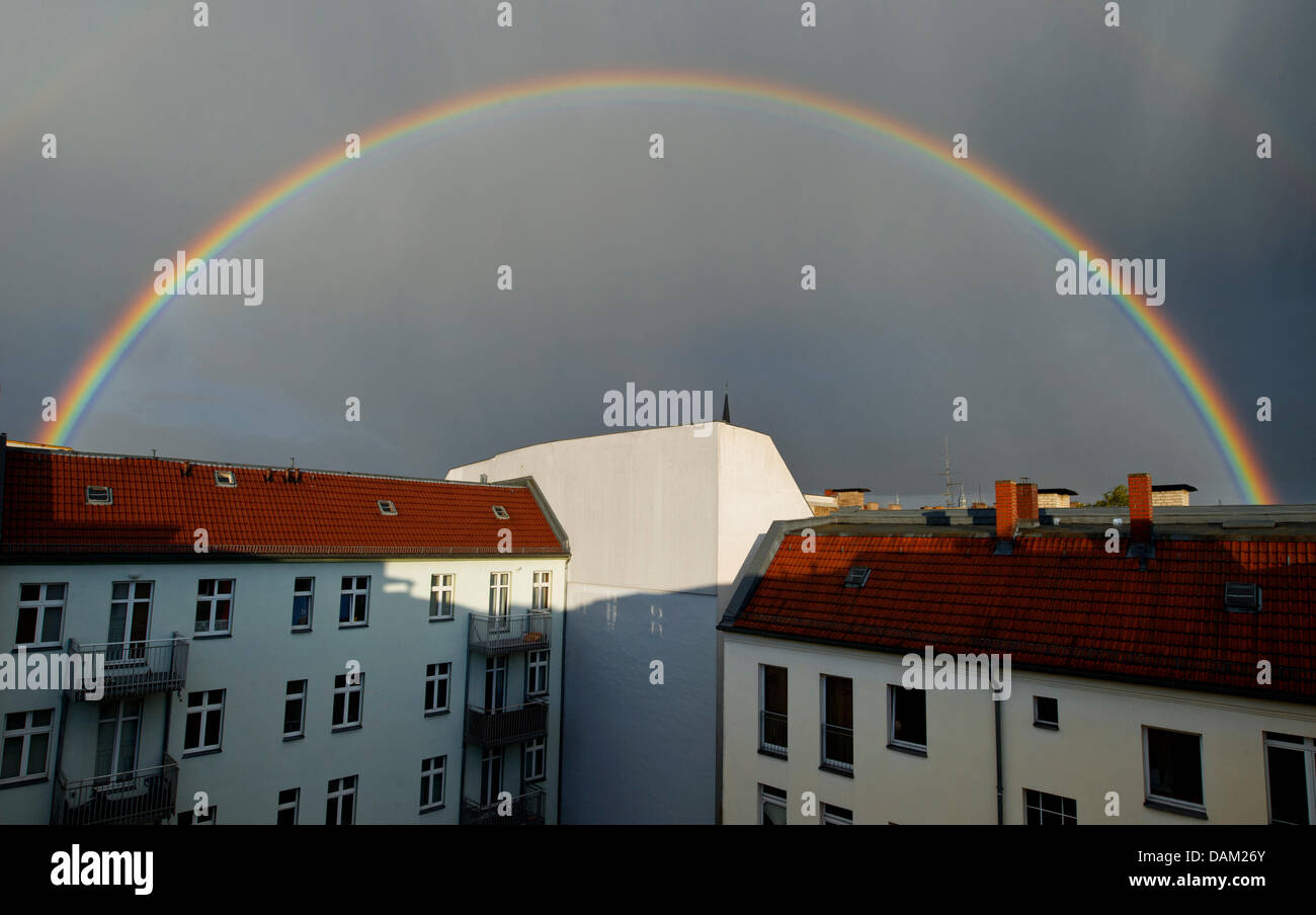 A rainbow spreads across roofs in Berlin-Friedrichshain, Germany, 15 May 2011. A rainbow appears when light breaks inside the rain drops. Photo: Soeren Stache Stock Photo