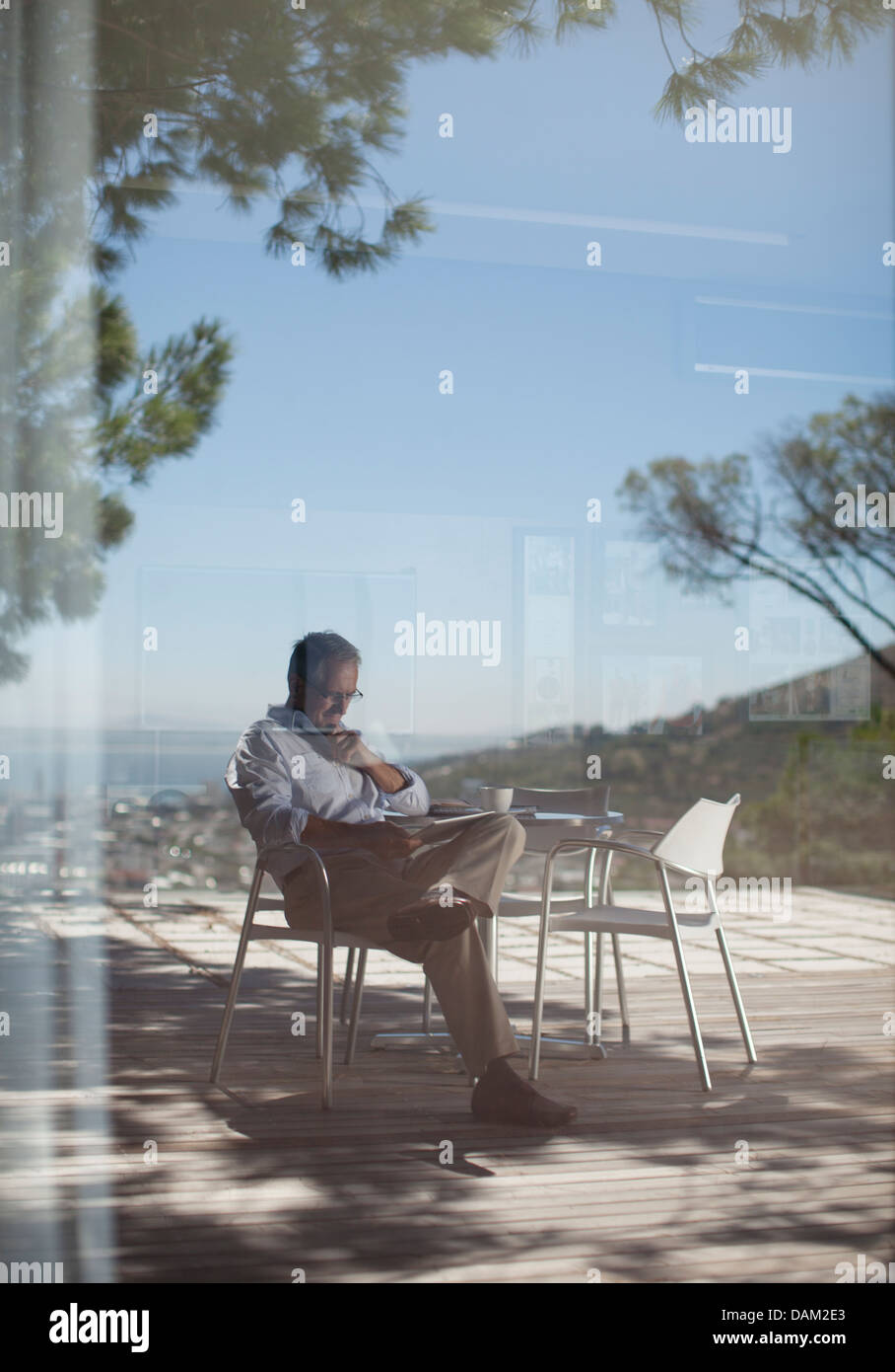 Man using tablet computer outdoors Stock Photo