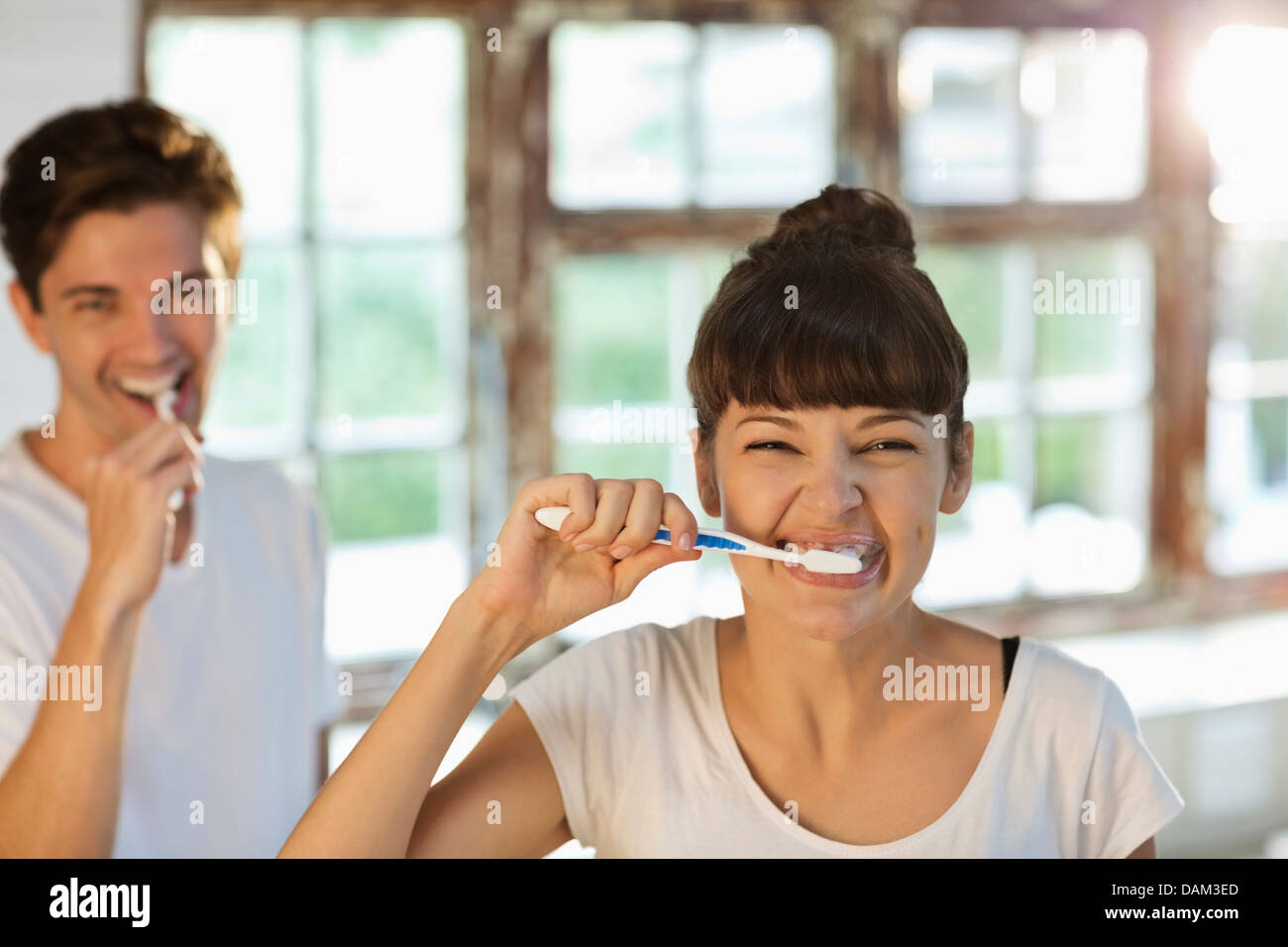Couple brushing their teeth together Stock Photo Alamy