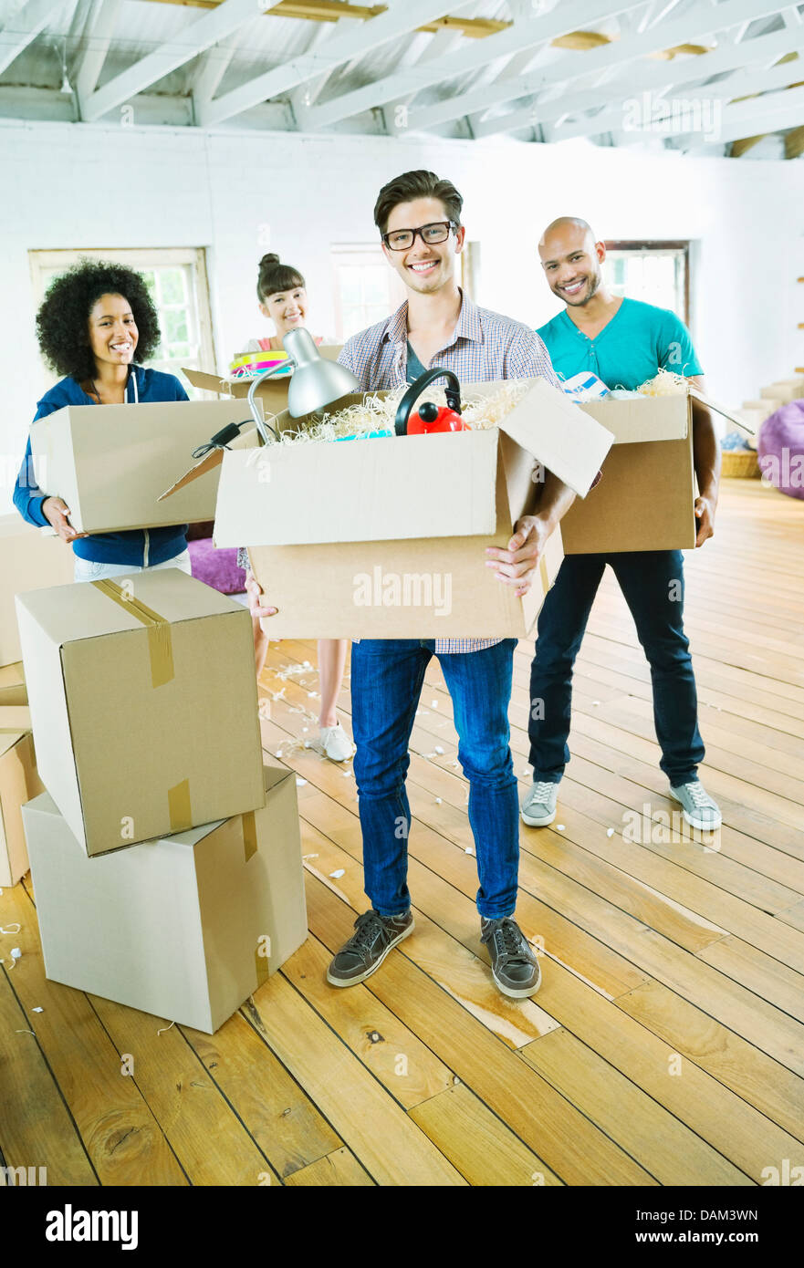 Friends unpacking boxes in new home Stock Photo Alamy