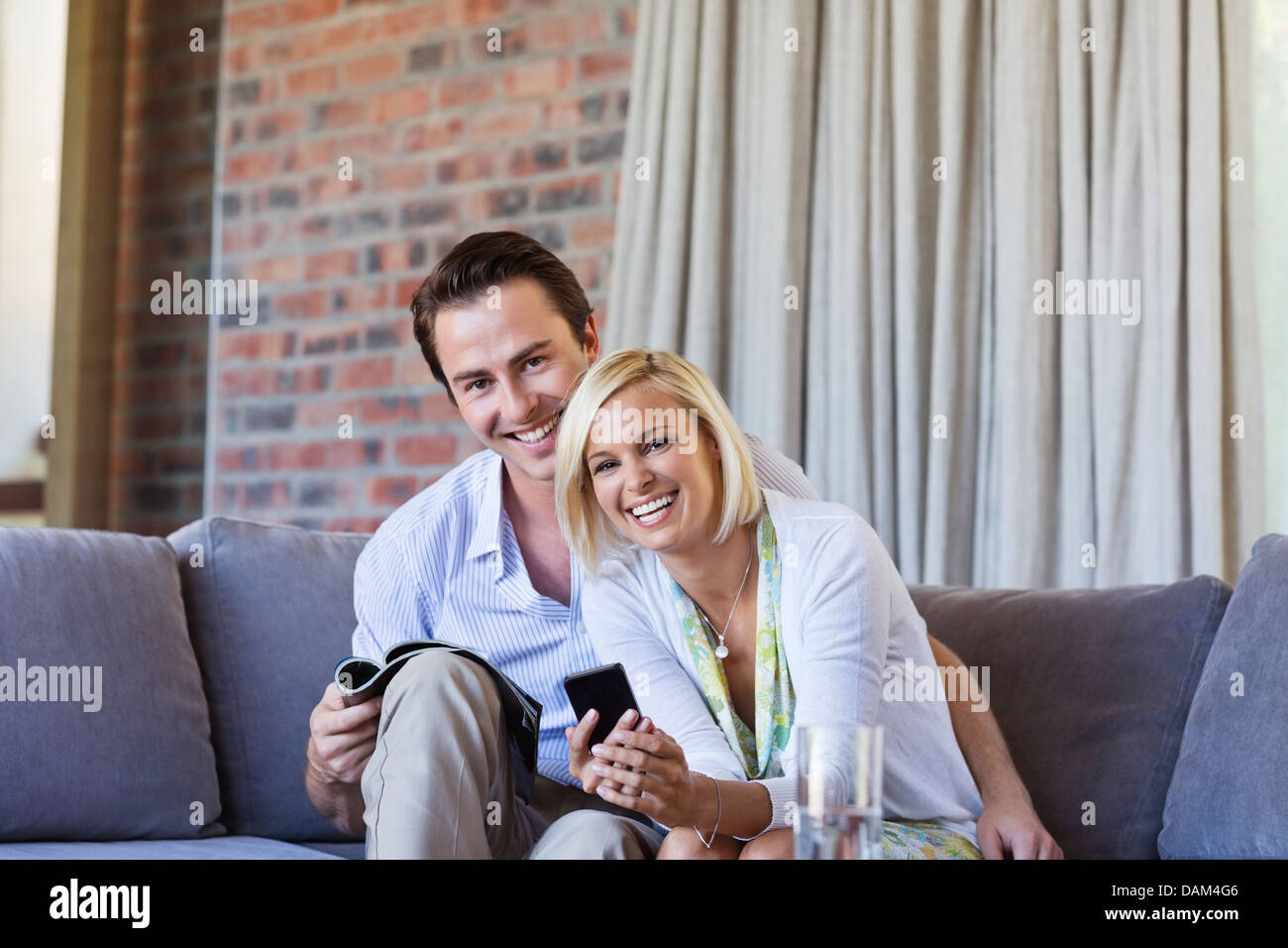 Couple relaxing on sofa together Stock Photo