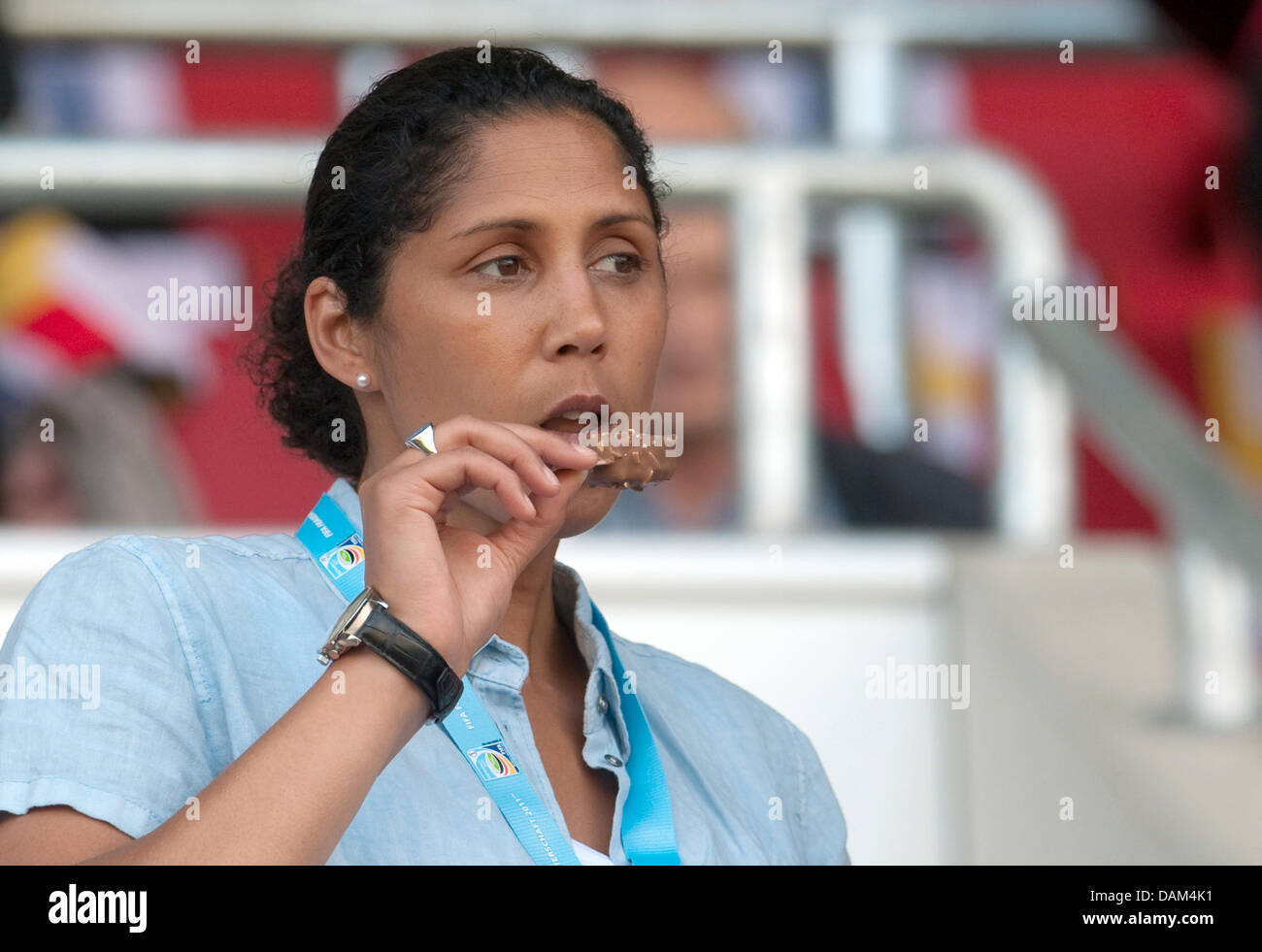 Steffi Jones, predsident of the organisation committee for the Women's World Cup 2011 and former soccer player, eats an ice-cream during the soccer friendly match Germany vs. North Korea in Ingolstadt, Germany, 21 May 2011. Photo: Andreas Gebert Stock Photo