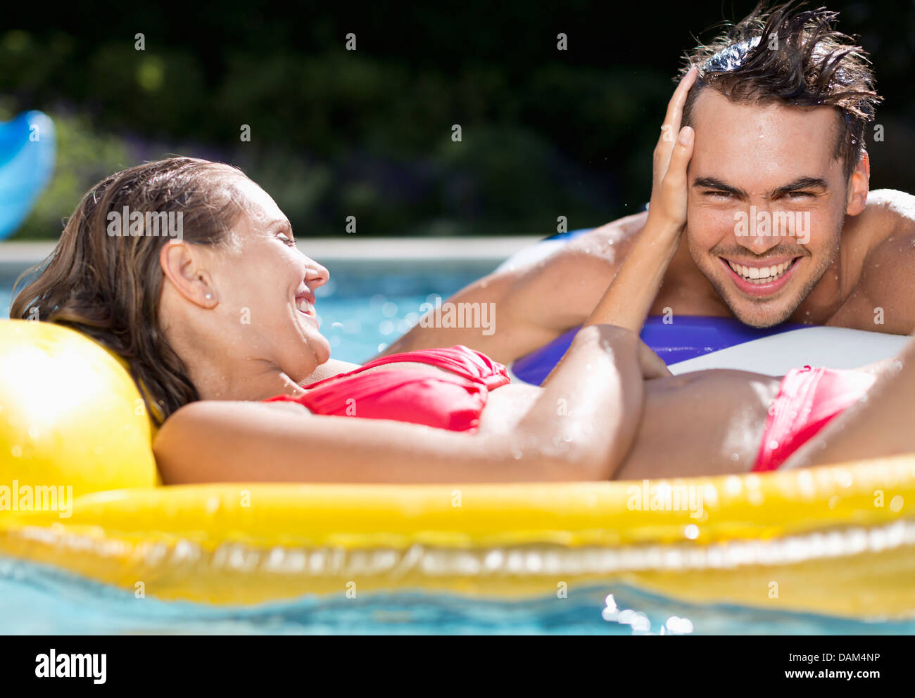 Couple relaxing in swimming pool Stock Photo