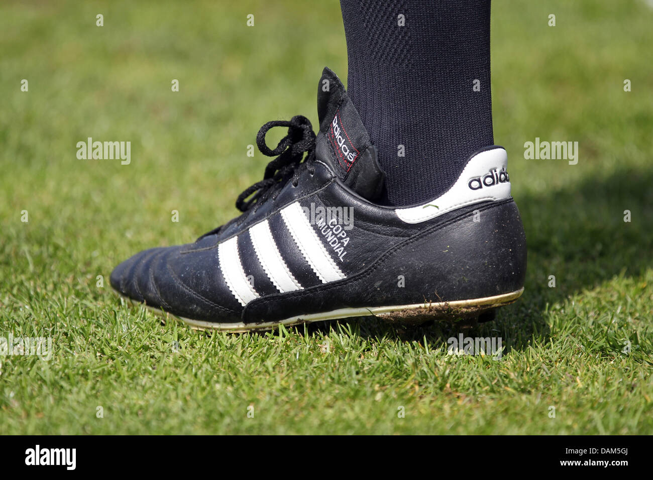 A linesman wearing a soccer shoe model 'Copa Mundial' made by sports wear manufacturer adidas stands on the pitch during the second division Bundesliga soccer match between SpVgg Greuther Fuerth and Fortuna Duesseldorf at the Trolli Arena in Fuerth, Germany, 15 May 2011. Photo: Daniel Karmann Stock Photo