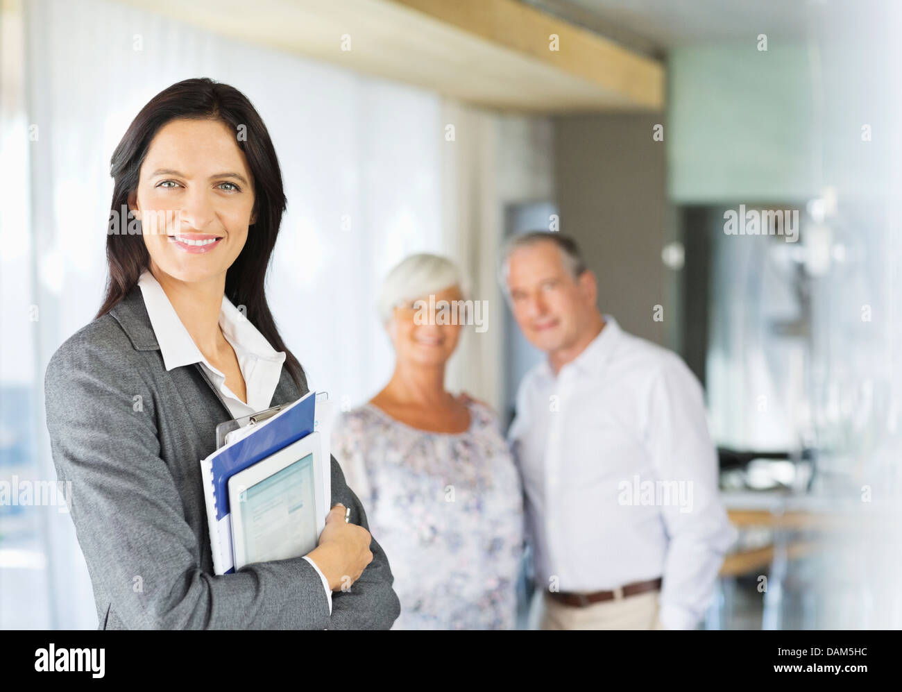 Financial advisor holding folders and tablet computer Stock Photo