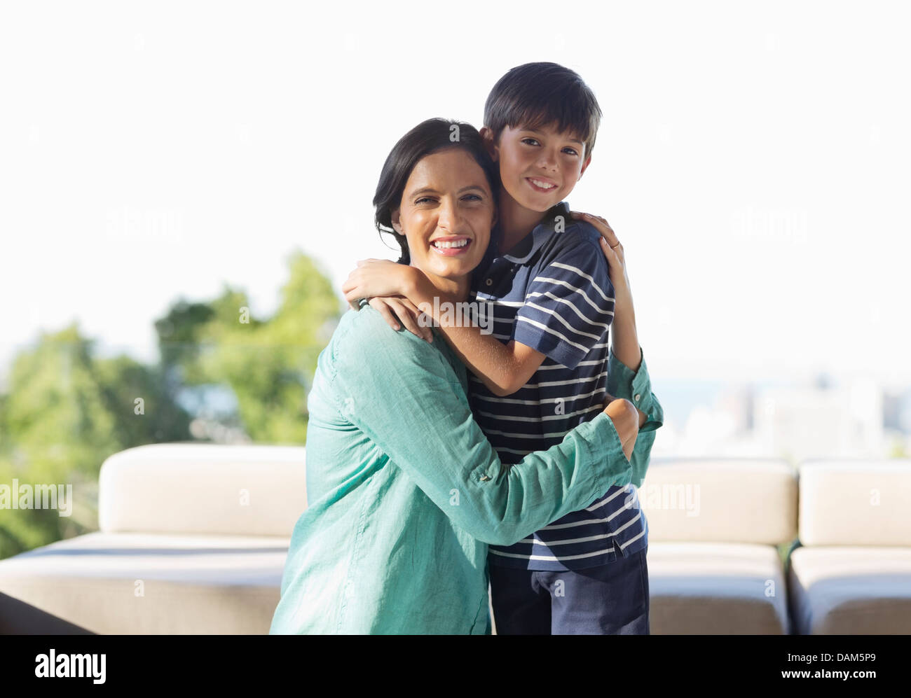 Mother and son hugging outdoors Stock Photo