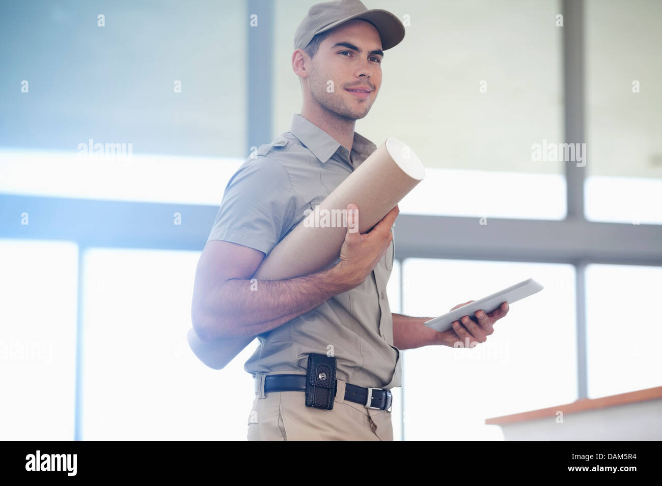 Delivery boy carrying package Stock Photo